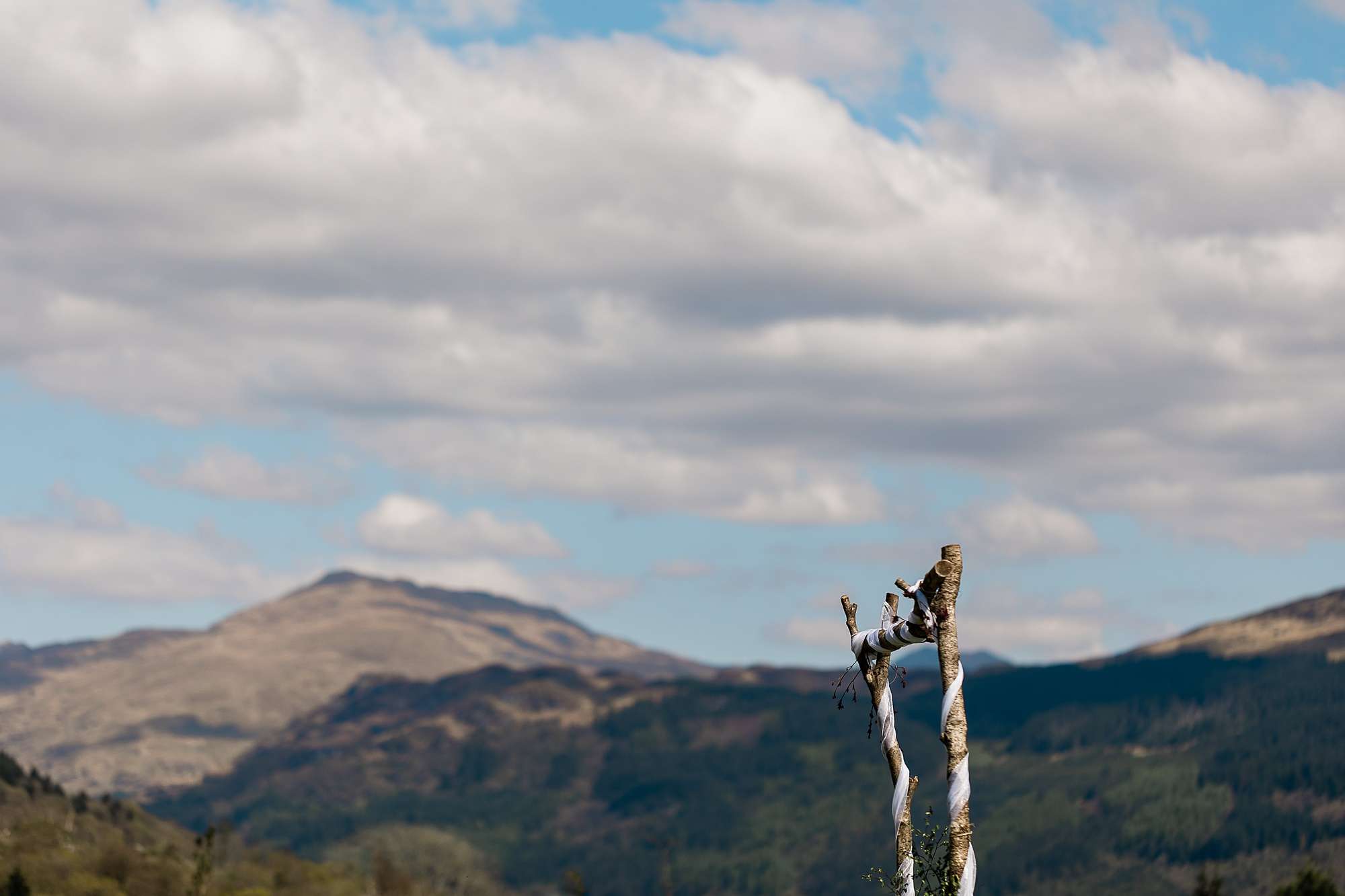 top of a wedding arch with Scottish hills in the background