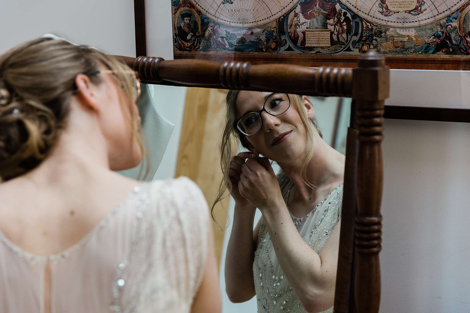 bride adjusting her earrings