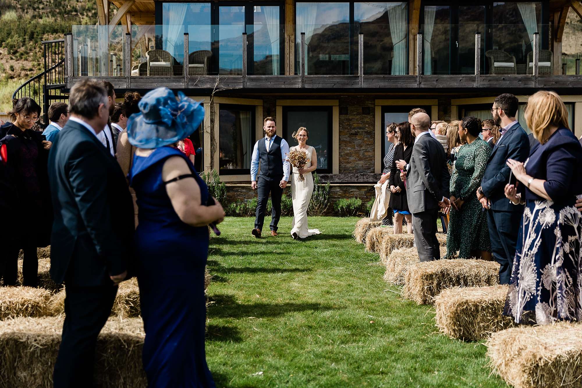 bride and groom walking up the aisle together at an outdoor wedding ceremony