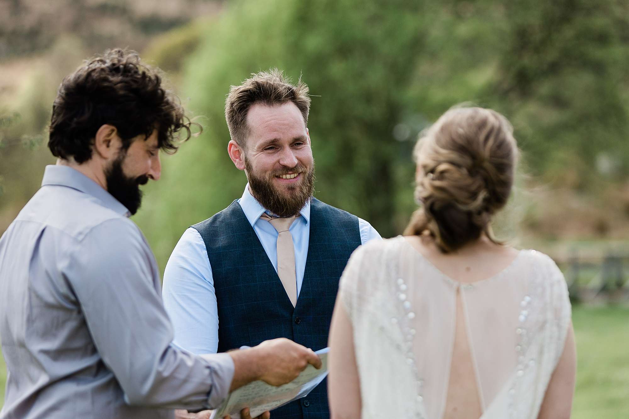 groom smiling at bride during his wedding ceremony