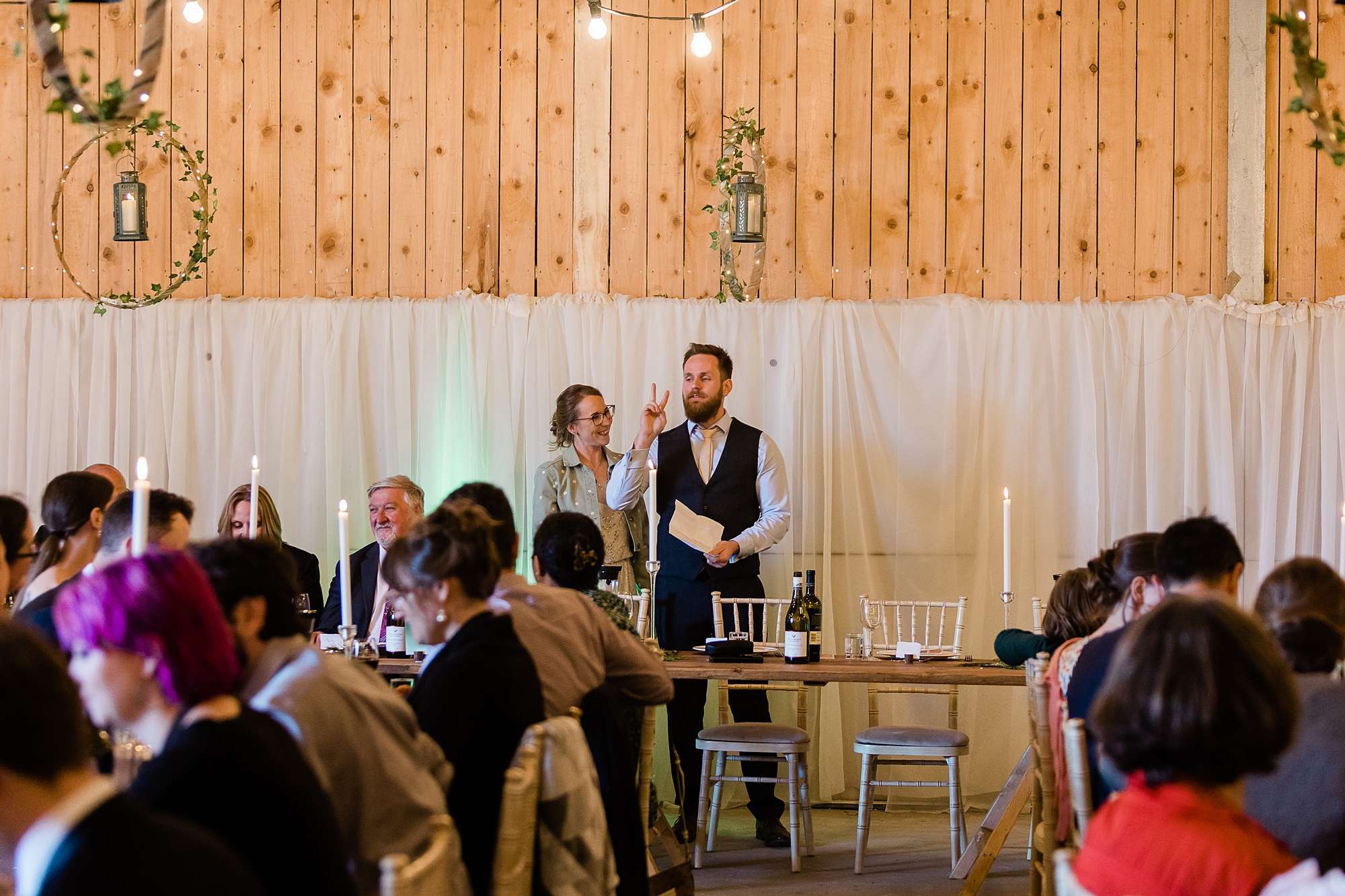 bride and groom giving a speech during their wedding reception