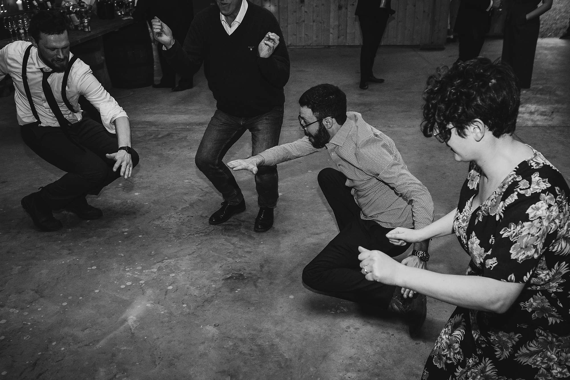 wedding guests twisting to the ground at a wedding at Carrick Castle Estate