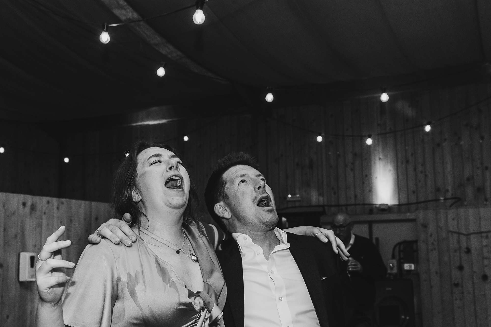 wedding guests singing at a wedding at Carrick Castle Estate