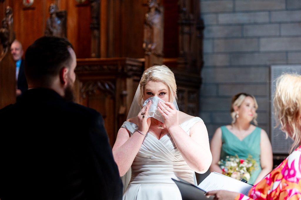 bride crying during wedding ceremony at Glasgow University Chapel