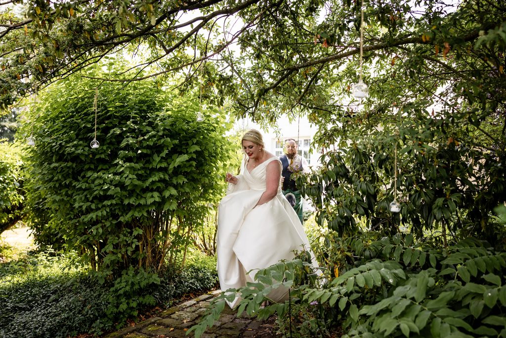 bride walking along garden path  at a Scottish garden wedding in Renfrewshire