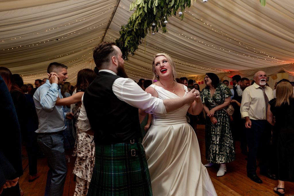 wedding guests dancing in a marquee at a Scottish garden wedding