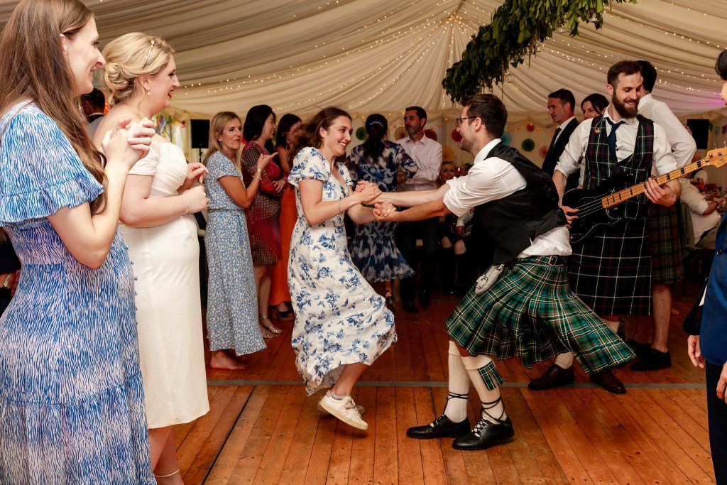 wedding guests dancing in a marquee at a Scottish garden wedding