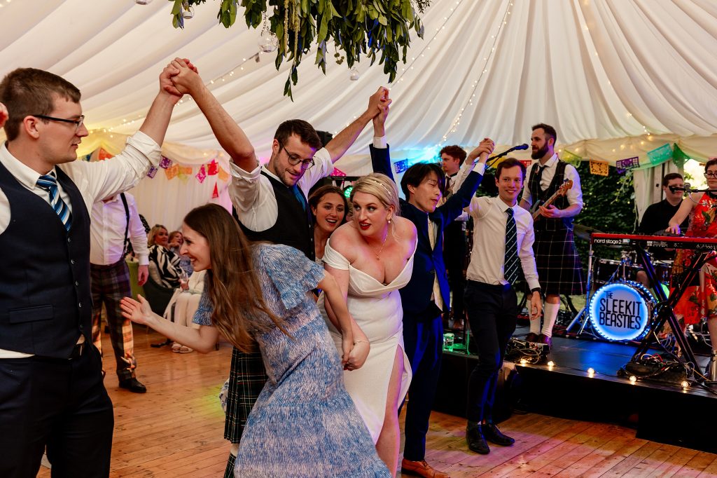 wedding guests dancing in a marquee at a Scottish garden wedding