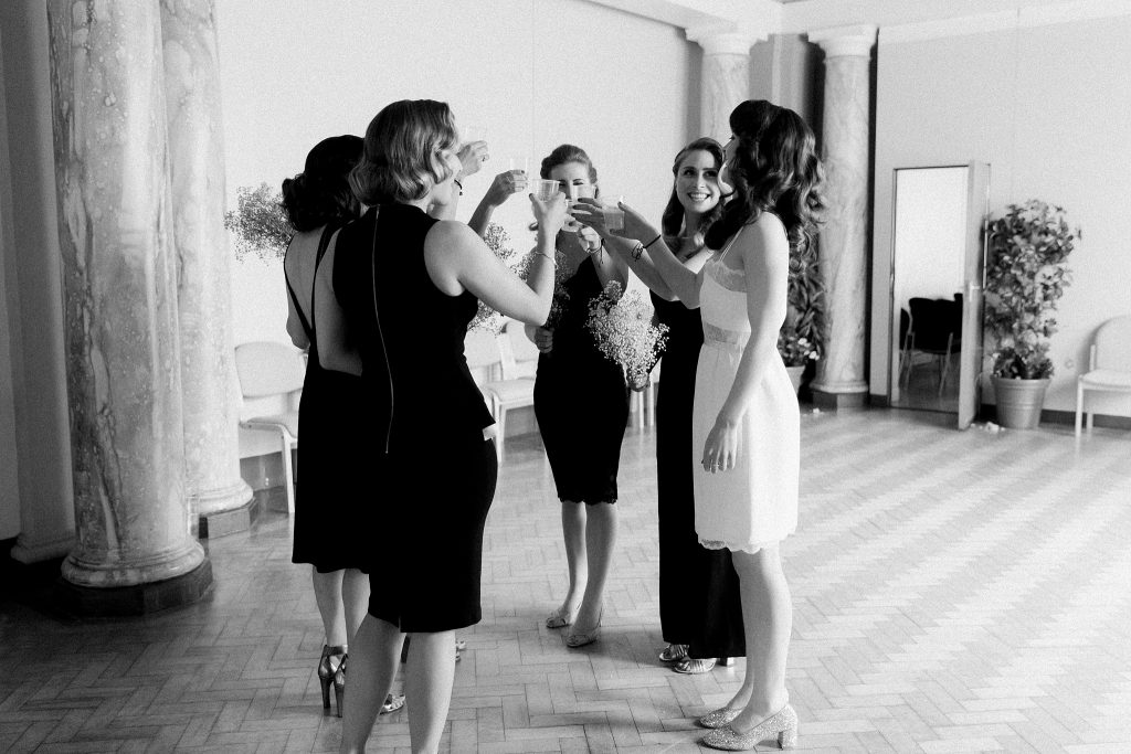 bride and bridesmaids having a drink in the upper area at a wedding in Leith Theatre