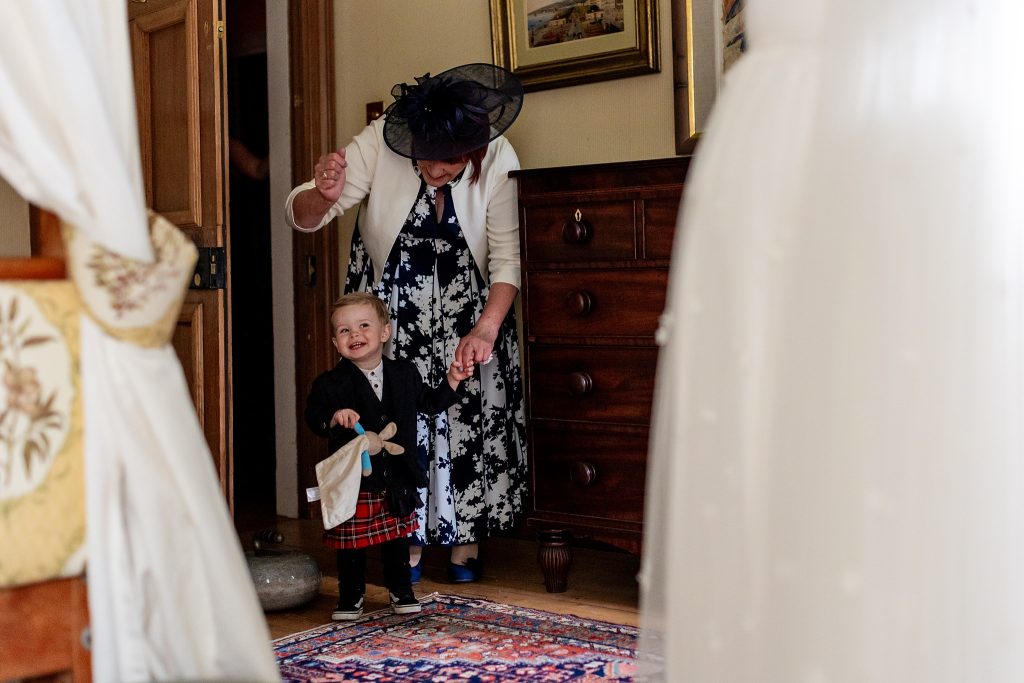little boy smiling at bride