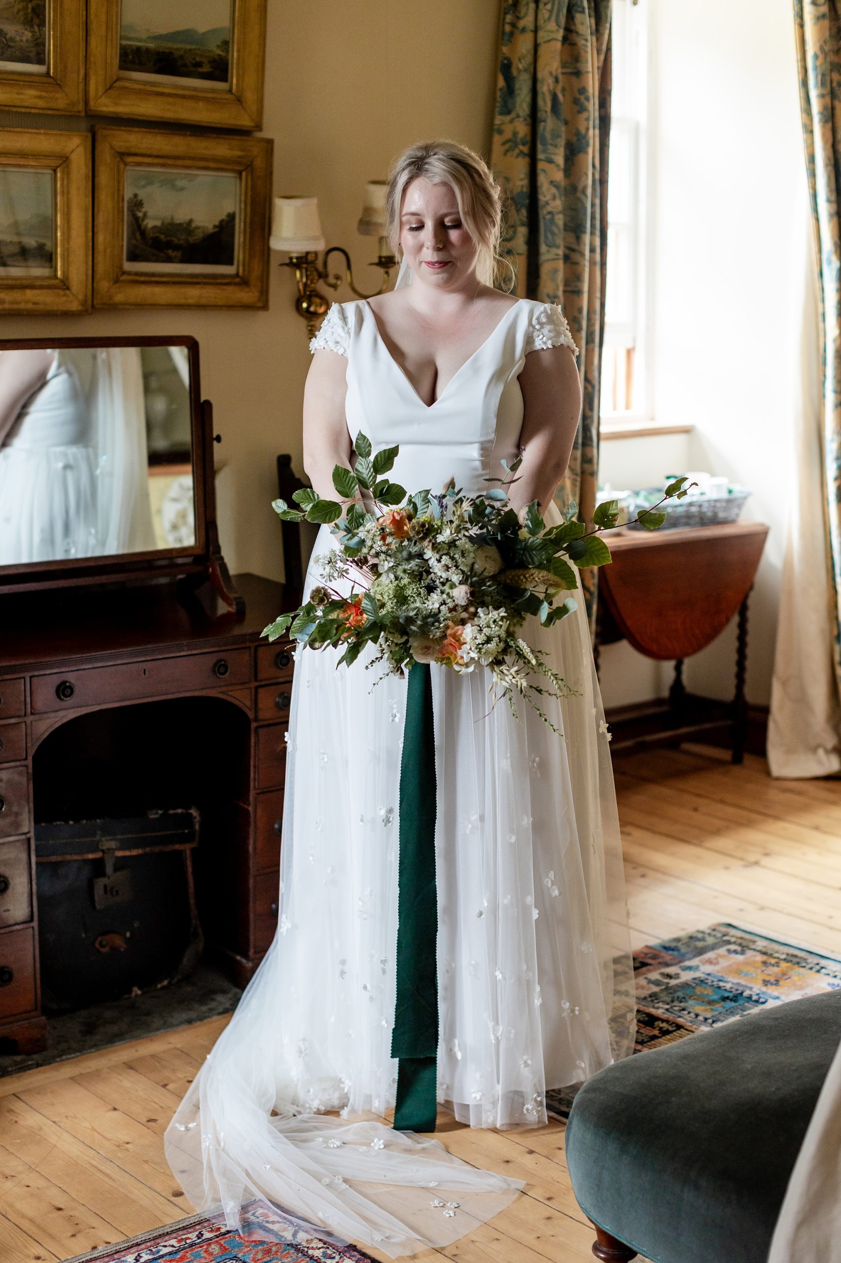 bride looking at her bouquet at Fingask Castle wedding