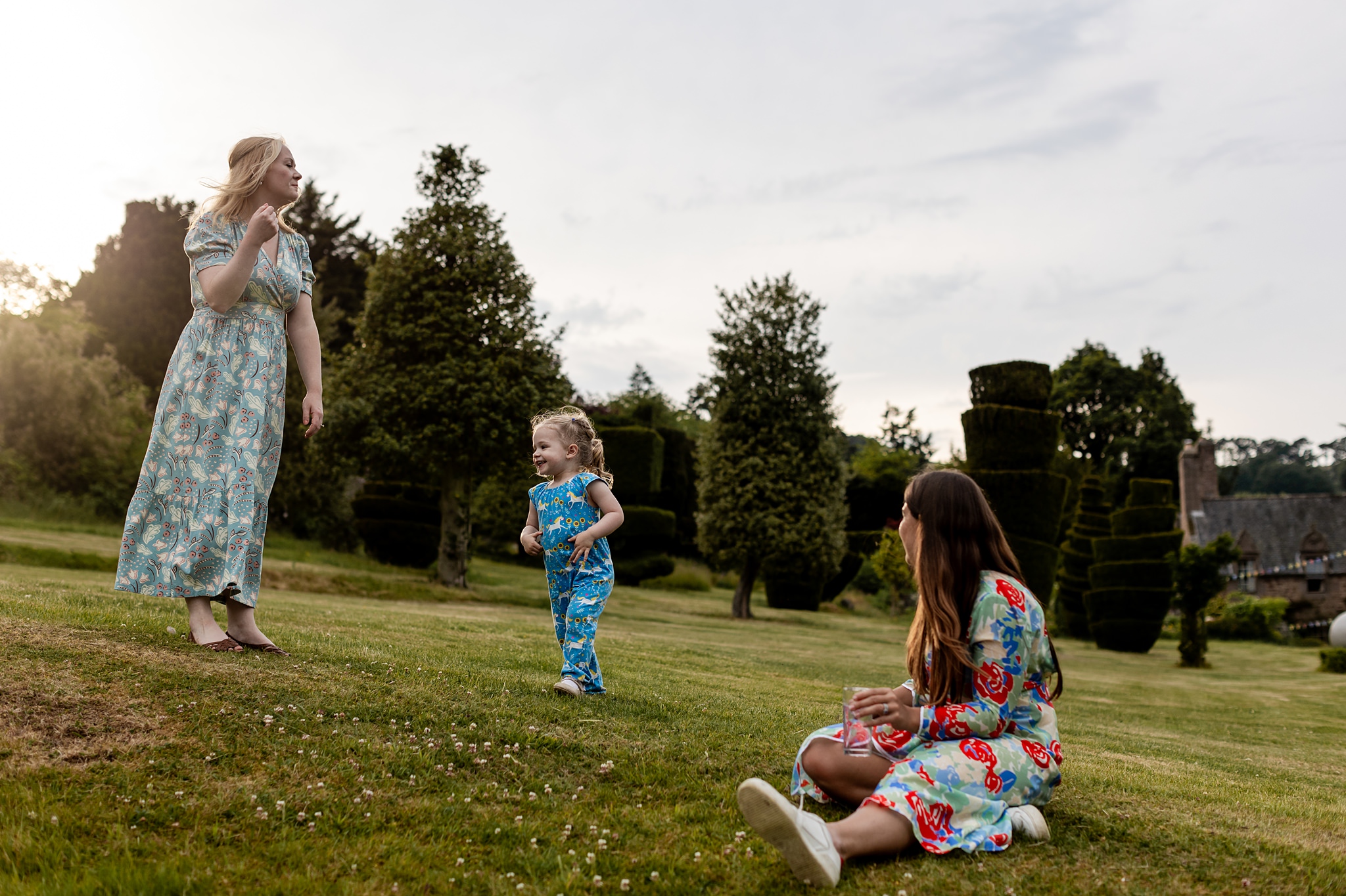 woman and child playing on lawn in the evening at Fingask Castle, in Perthshire