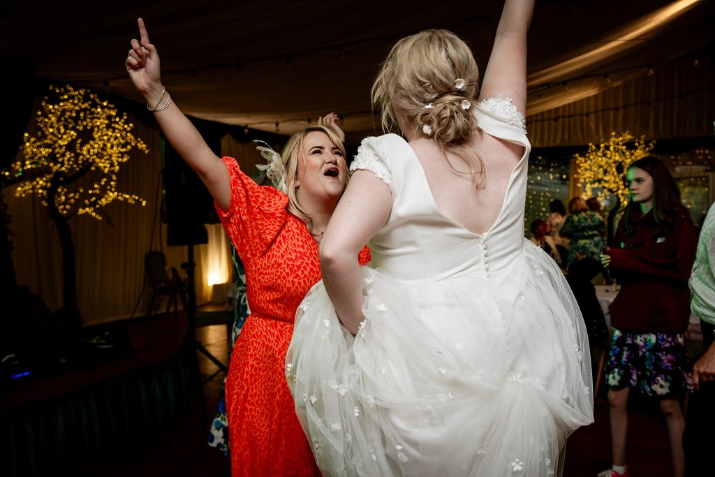 bride dancing with friend  at a wedding at Fingask Castle, Perthshire