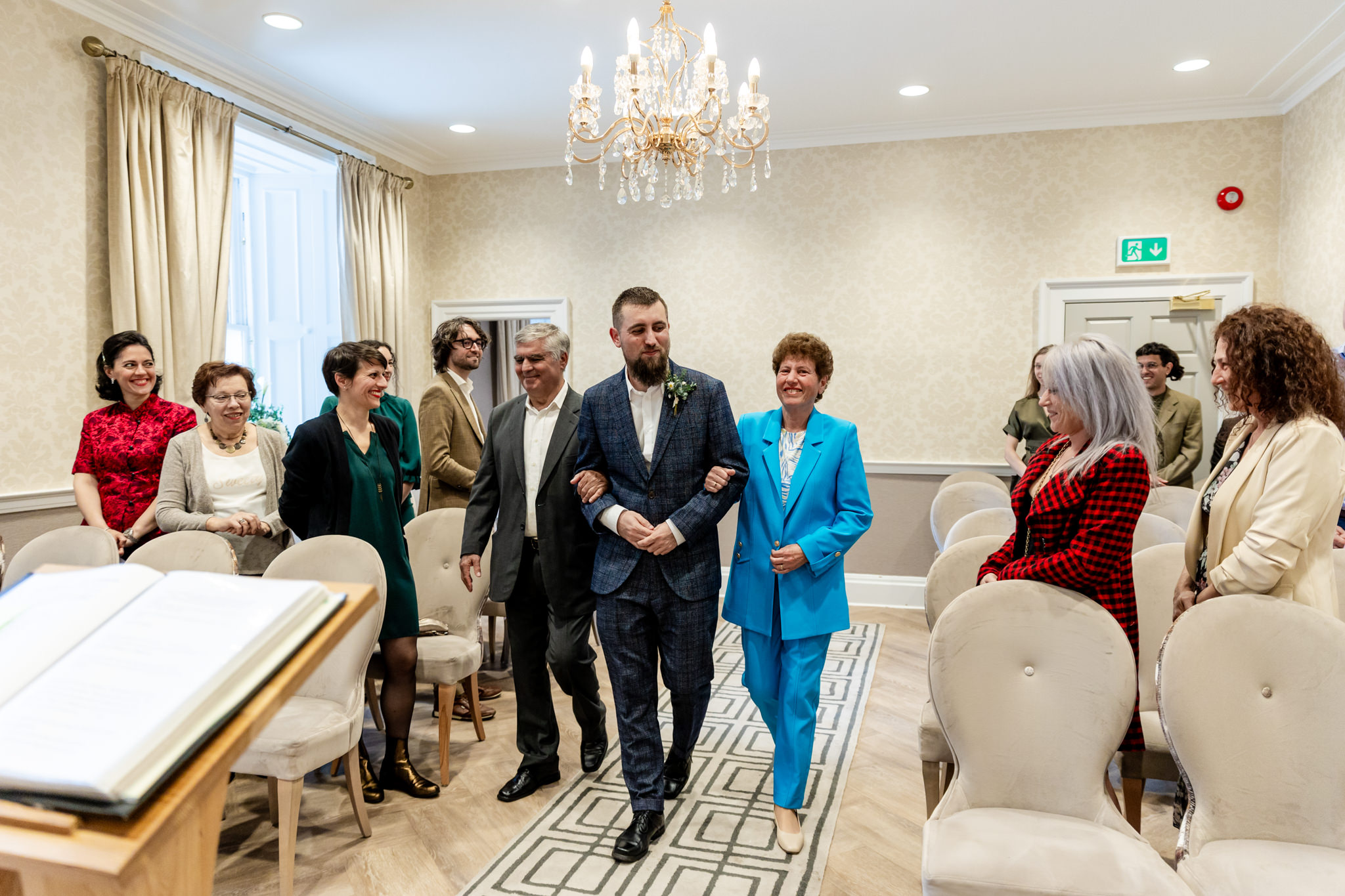 groom walking down the aisle with his parents at City Chambers wedding in Edinburgh