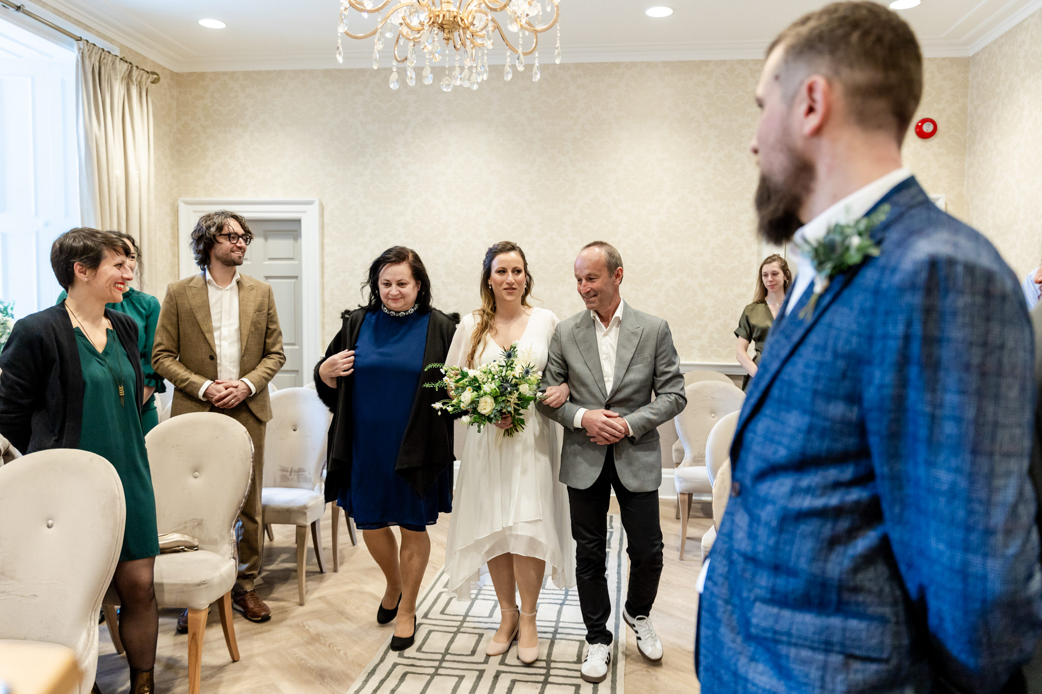 bride walking down the aisle with her parents at City Chambers wedding in Edinburgh