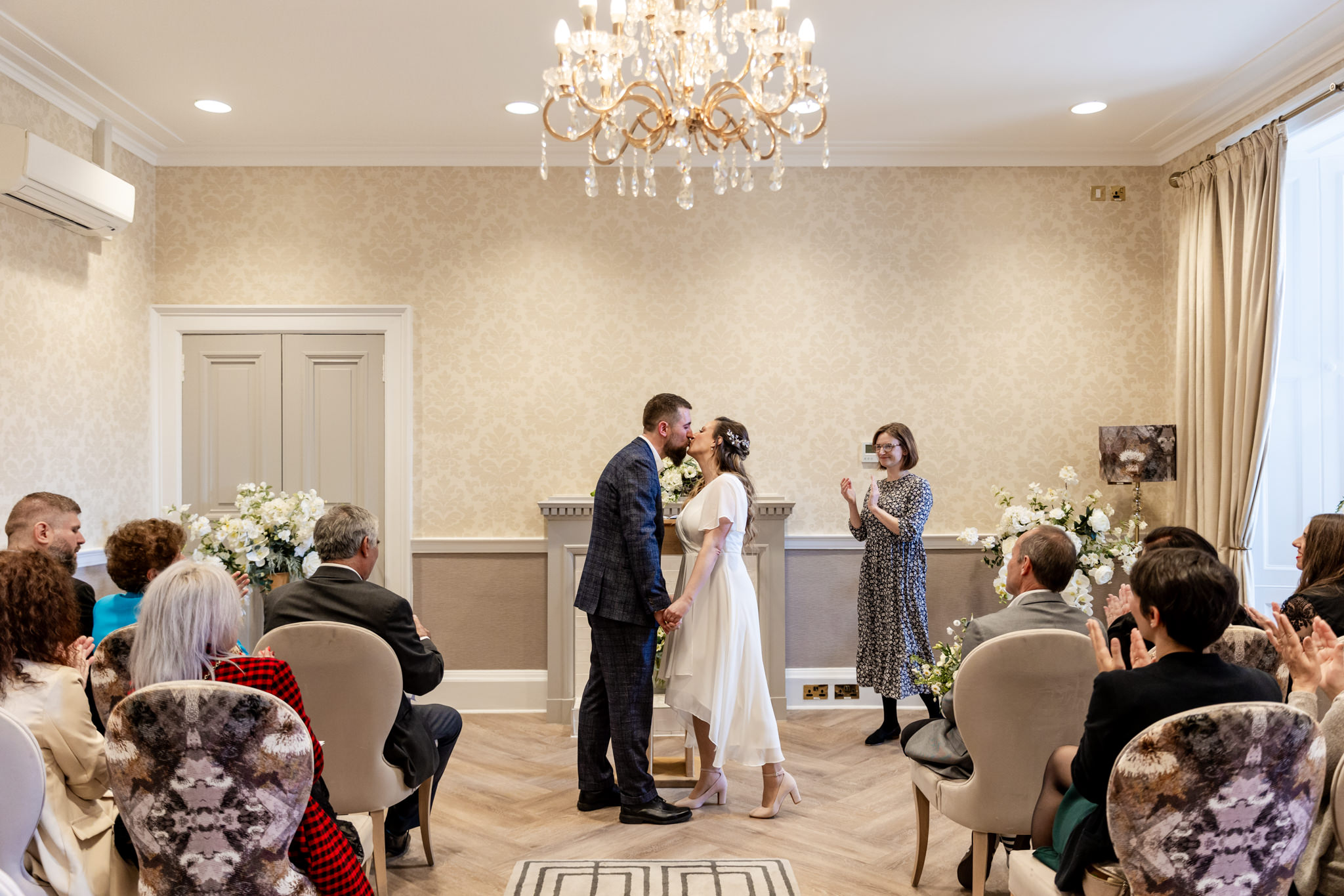 bride and groom first kiss at City Chambers wedding in Edinburgh