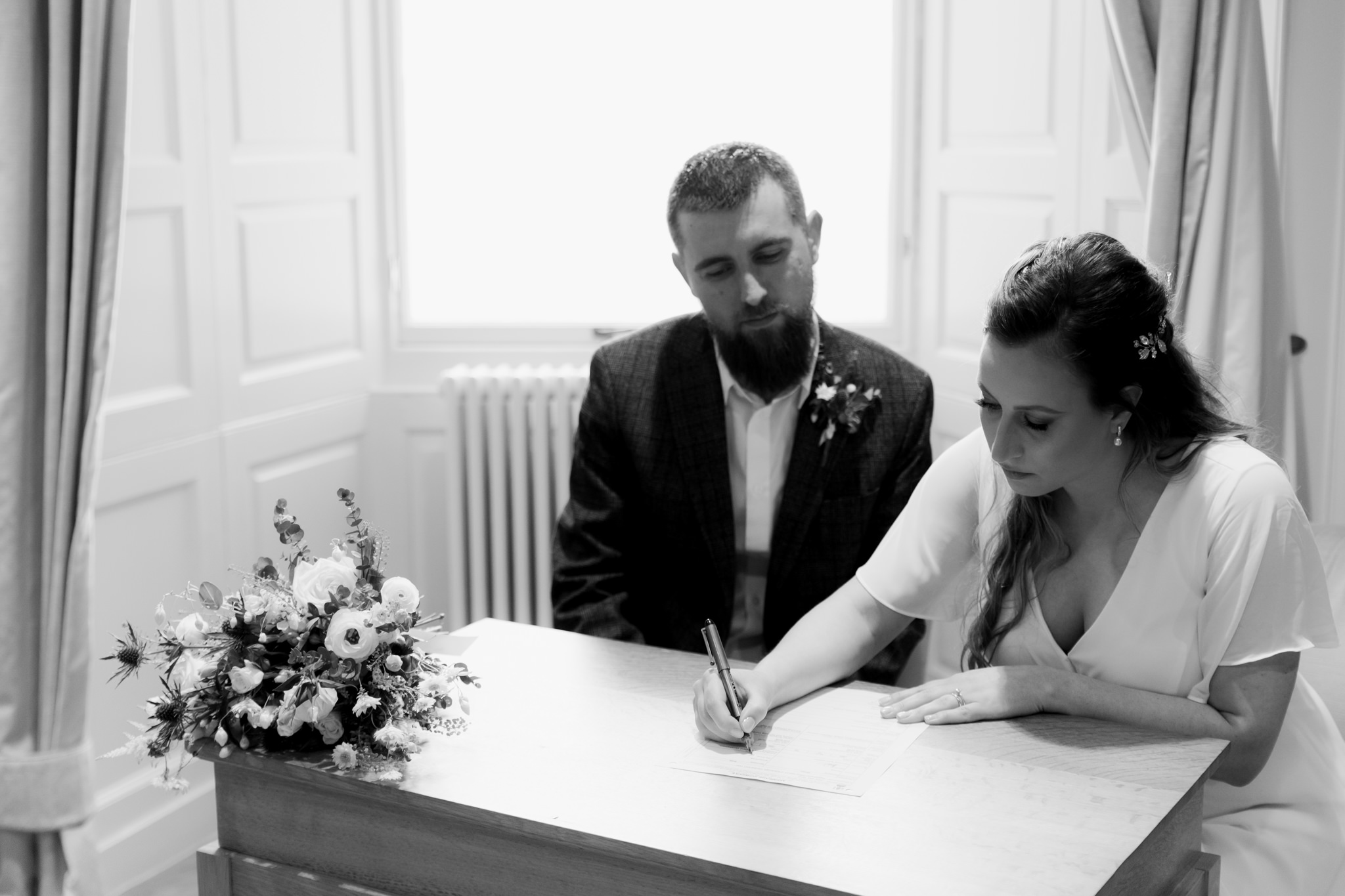 bride signing register at City Chambers wedding in Edinburgh