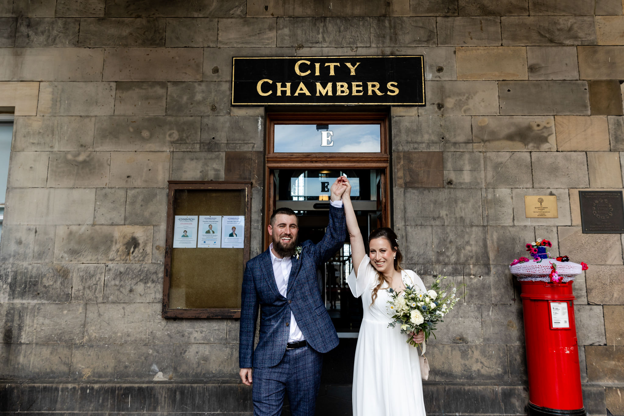 bride and groom outside entrance at City Chambers wedding in Edinburgh