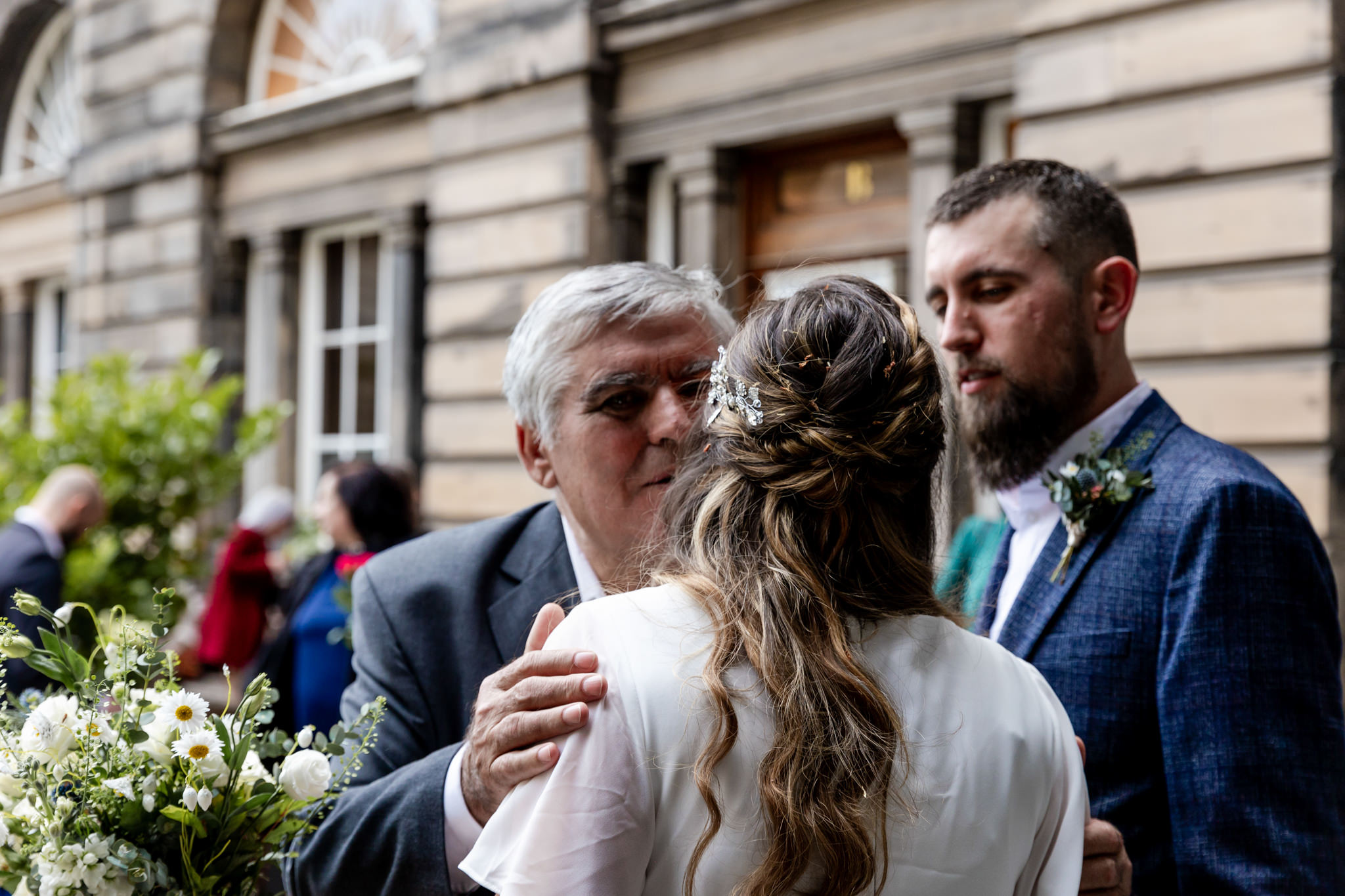 bride kissing a wedding guest