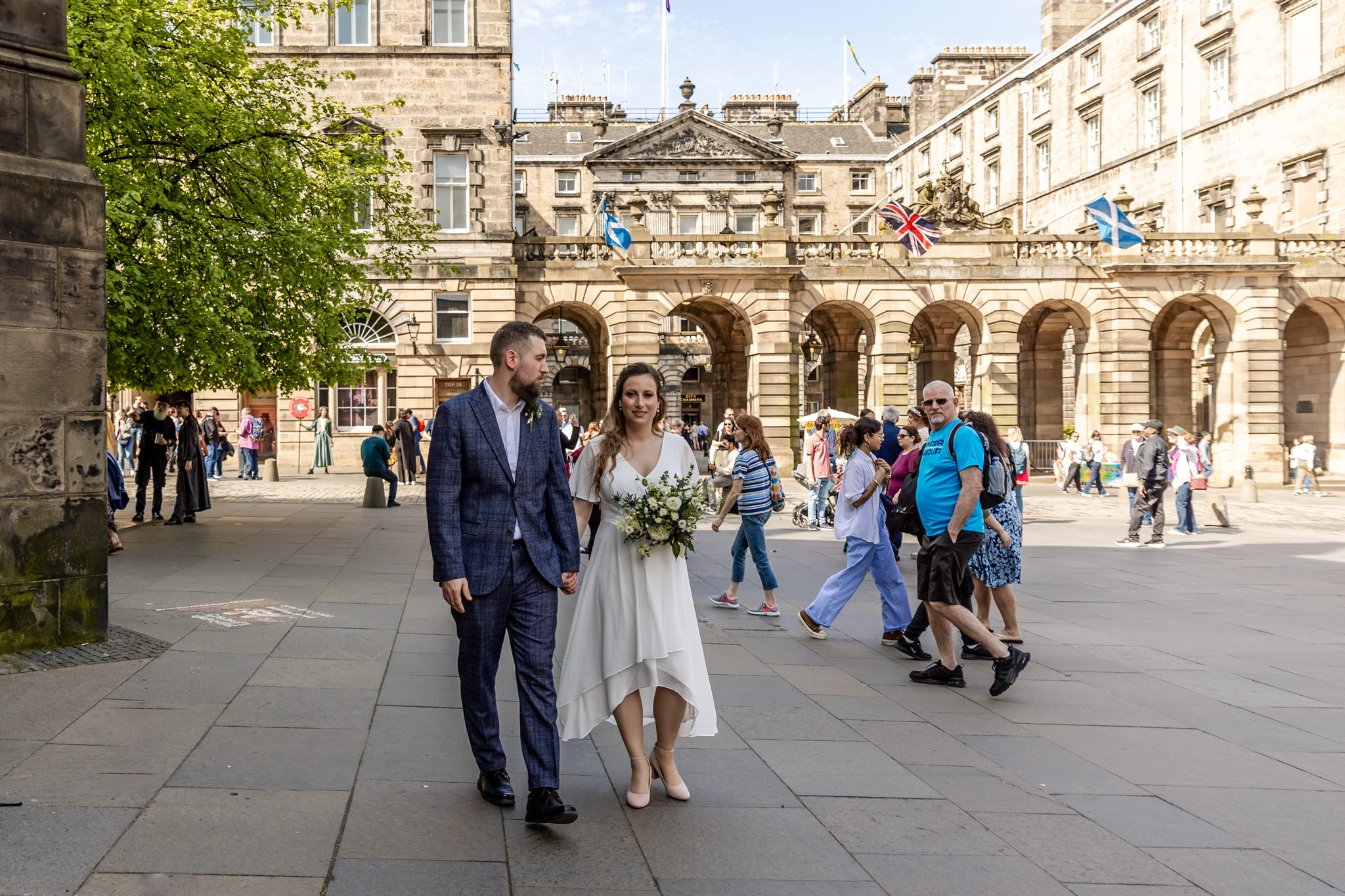 bride and groom walking towards Parliament Square in Edinburgh
