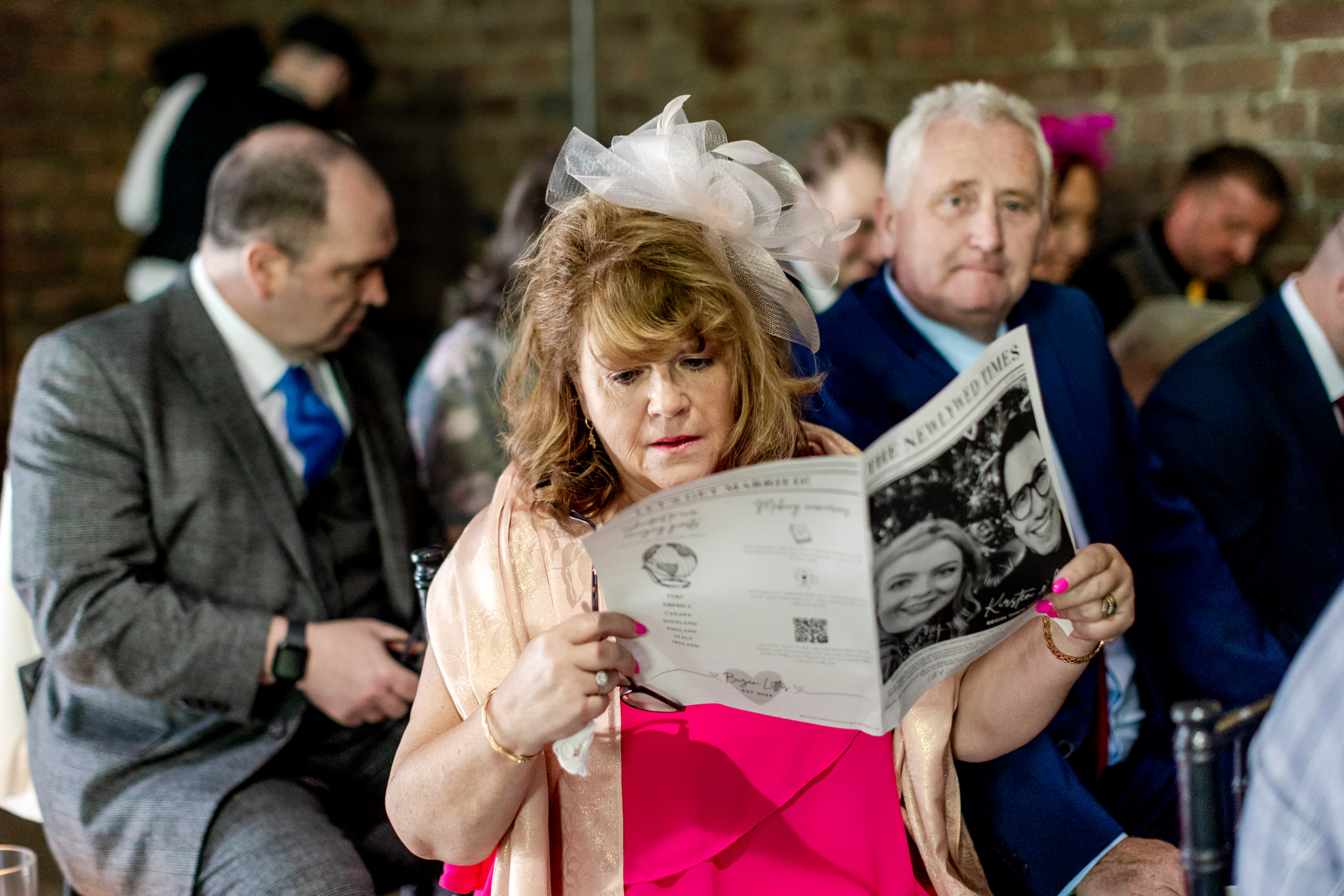 wedding guest reading a wedding newspaper