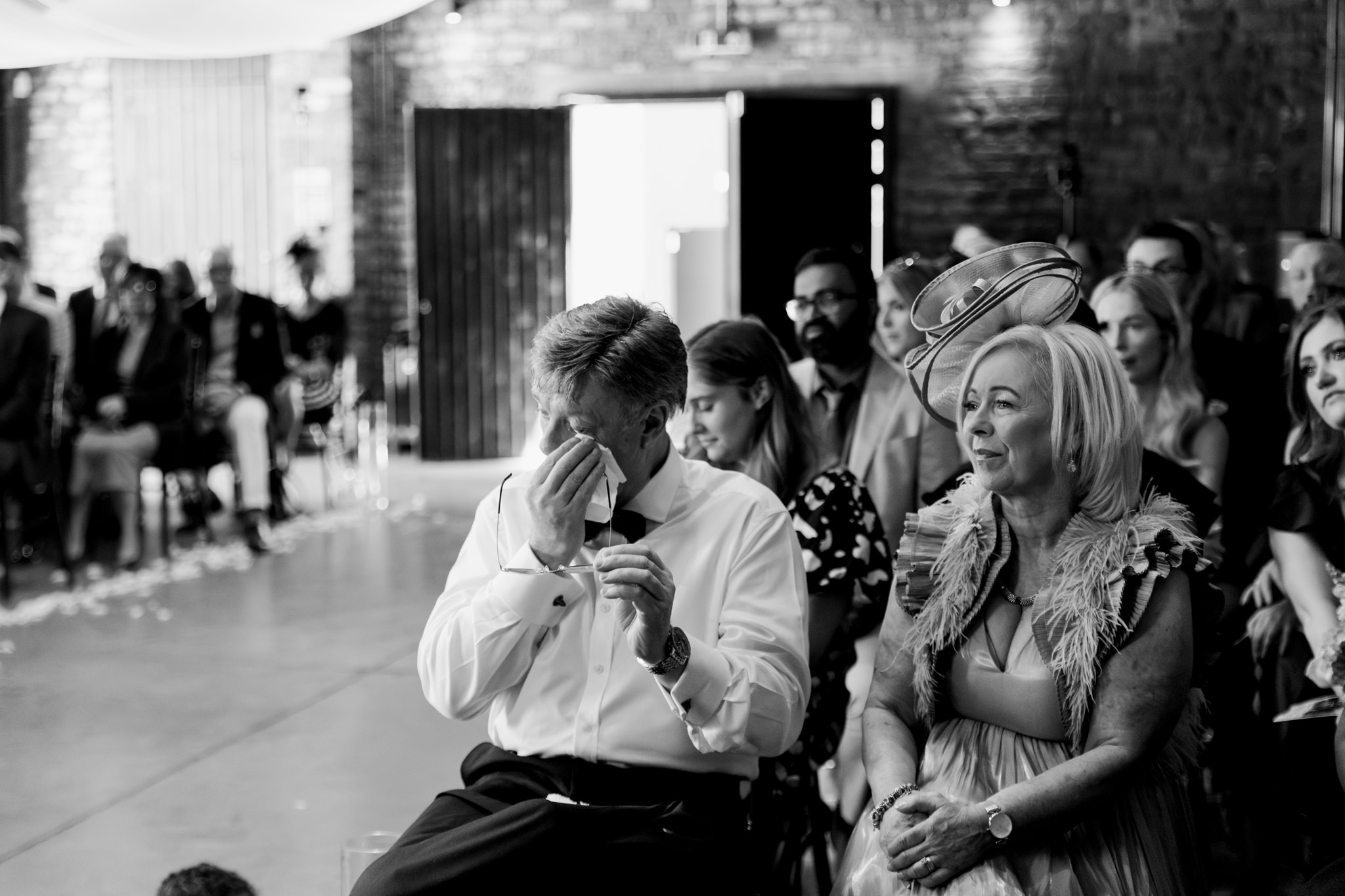 father of the bride wiping a tear from his eyes during a ceremony at a wedding at The Engine Works, Glasgow 