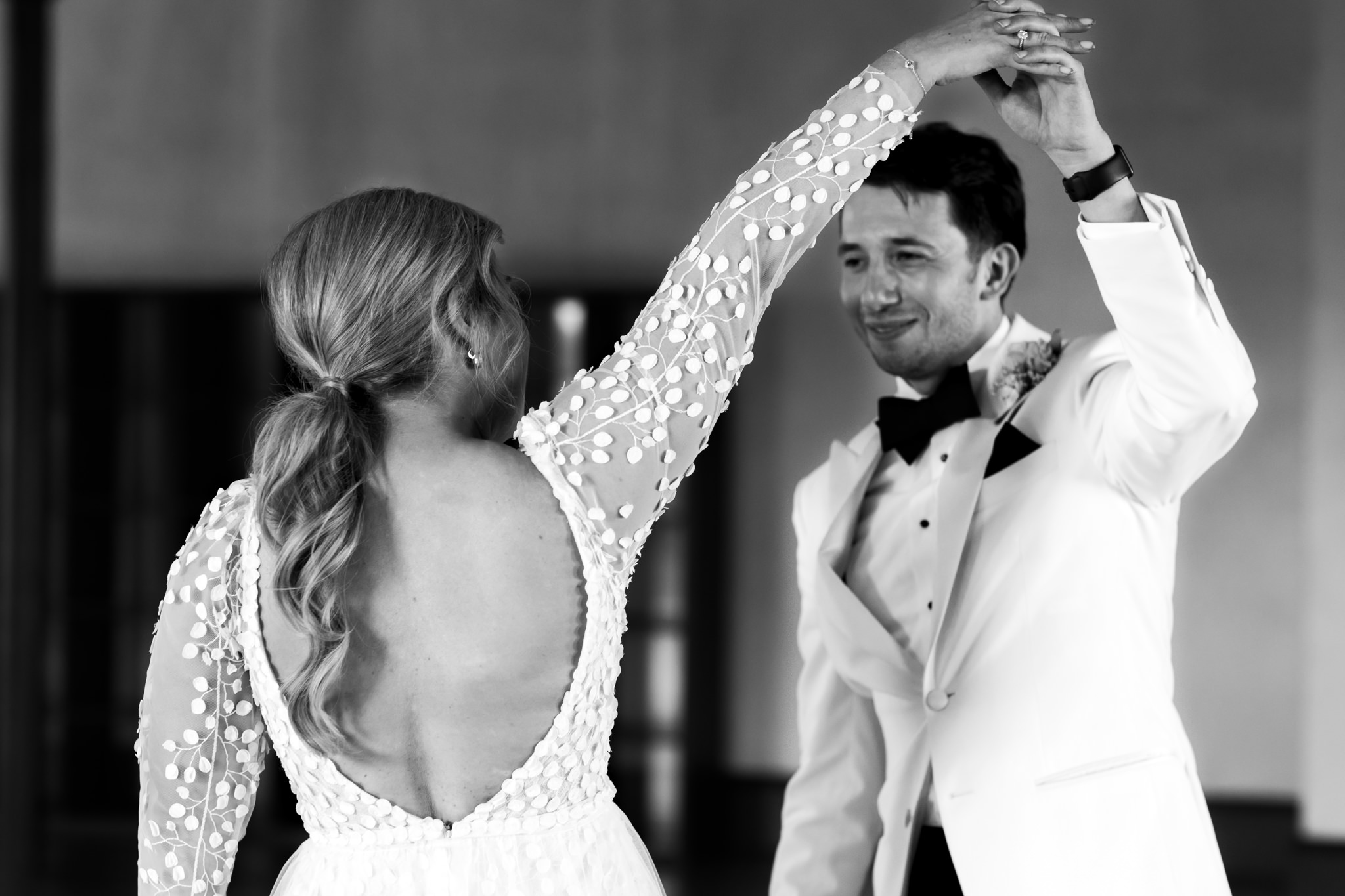 bride and groom twirling in a dance together