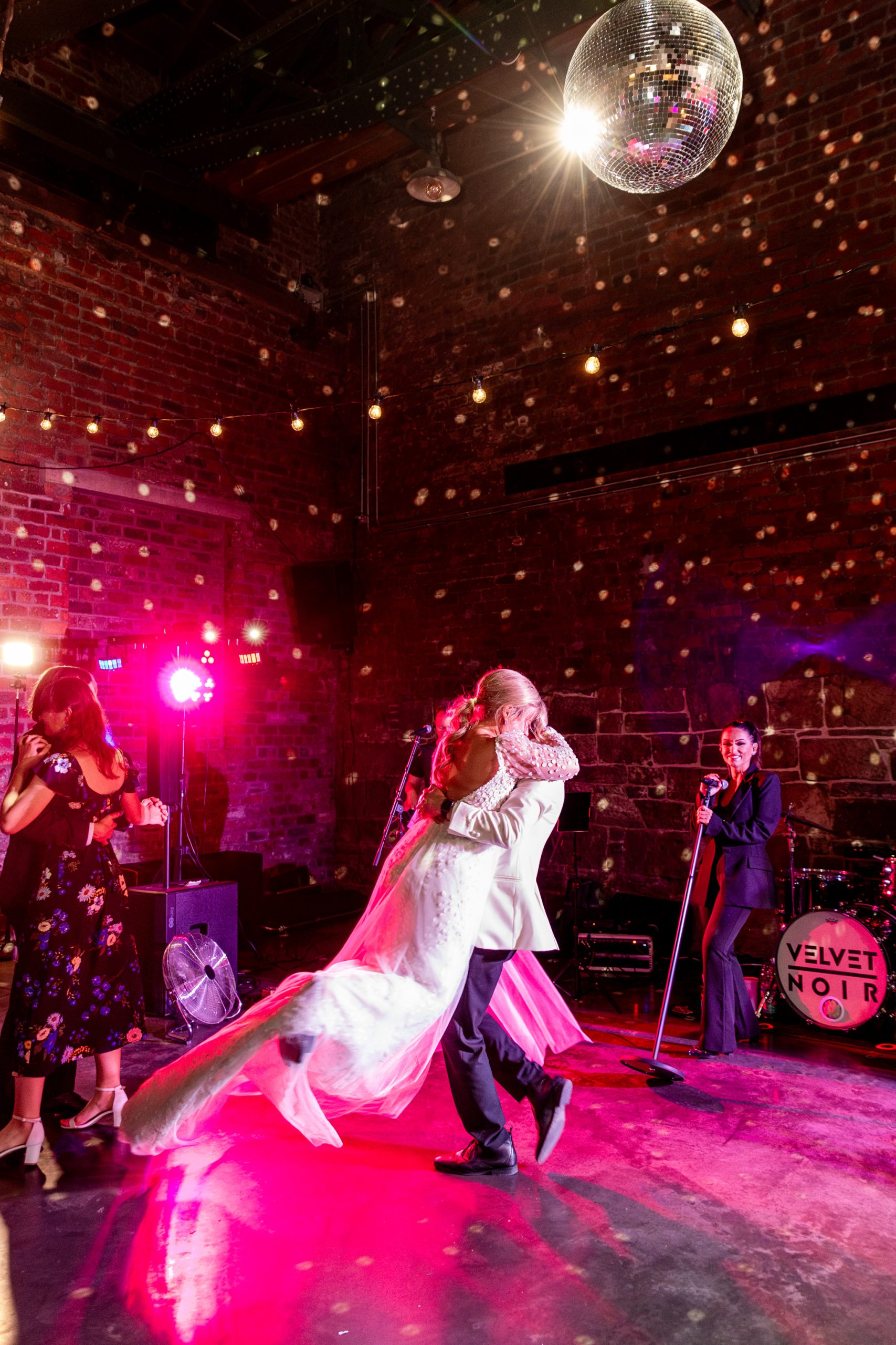 groom spinning bride around on the dancefloor under a discoball at a wedding at The Engine Works, Glasgow 