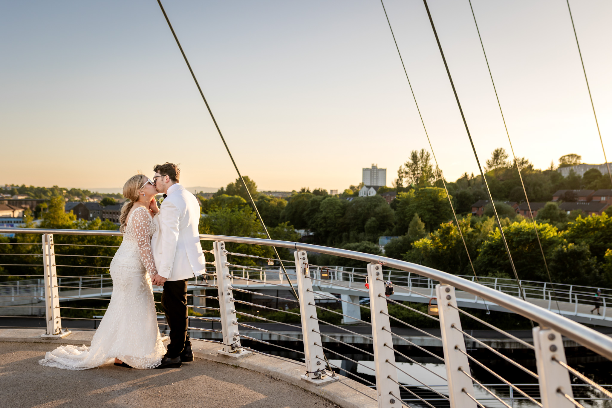 bride and groom in sunglasses kissing on Stockingfield Junction at the canal in Glasgow