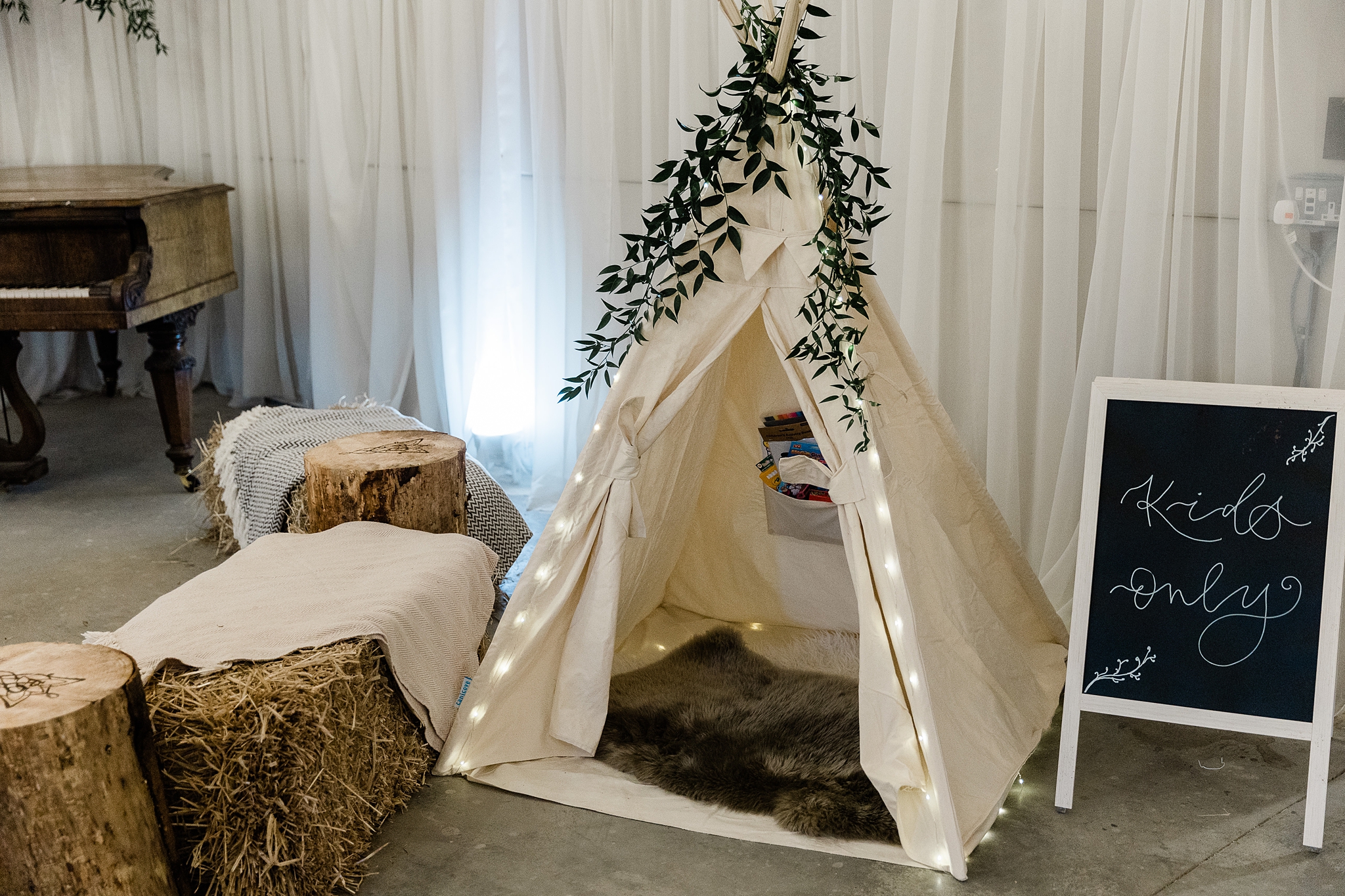 Kids only on a chalkboard with a linen tipi tent lined with a faux fur rug 