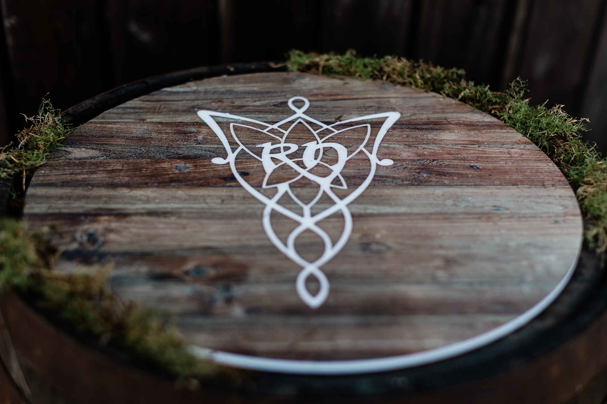 brown wooden barrel lid with celtic folklore elven decoration on it at a wedding in Scotland