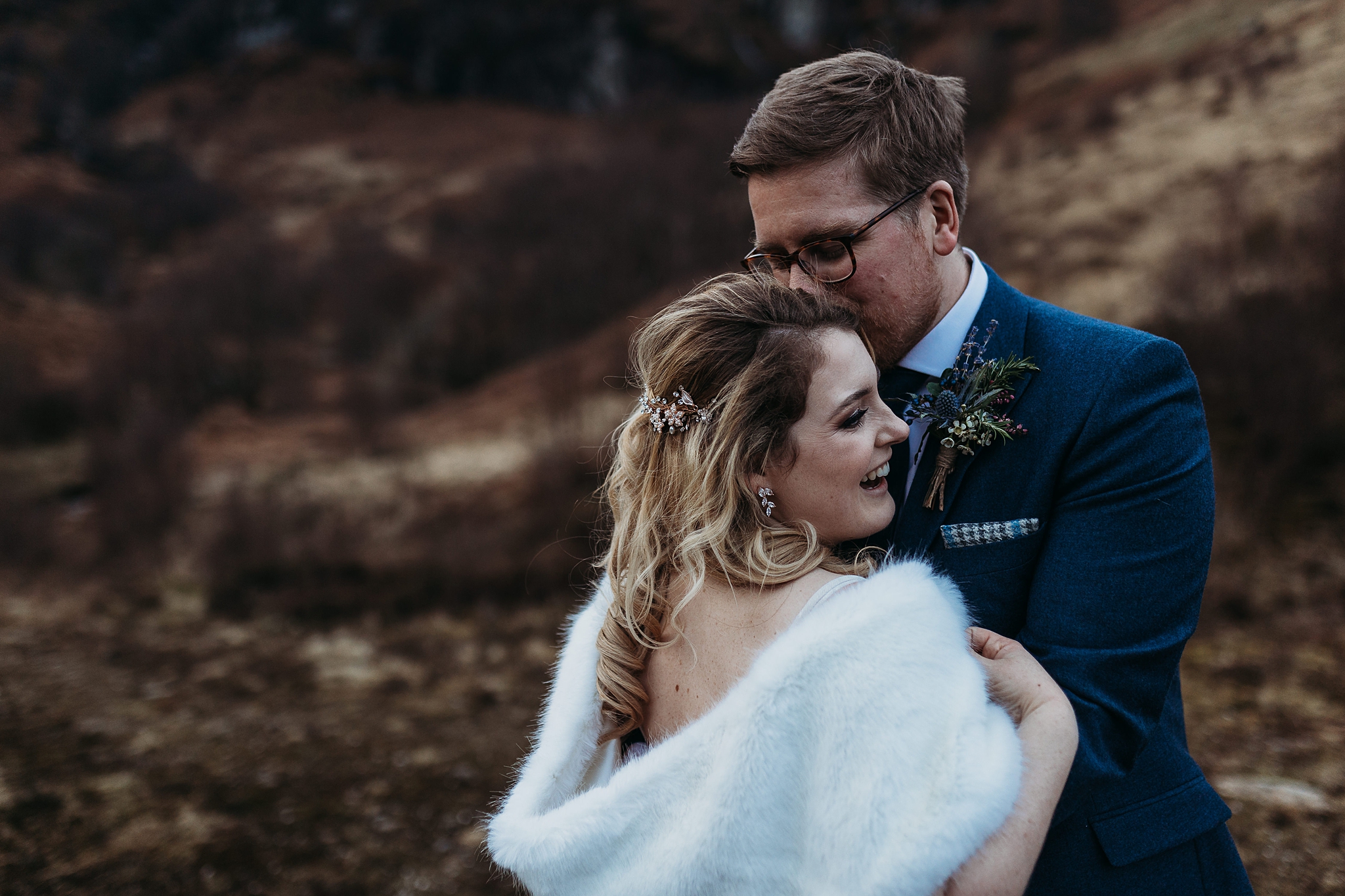 bride and groom kissing and laughing