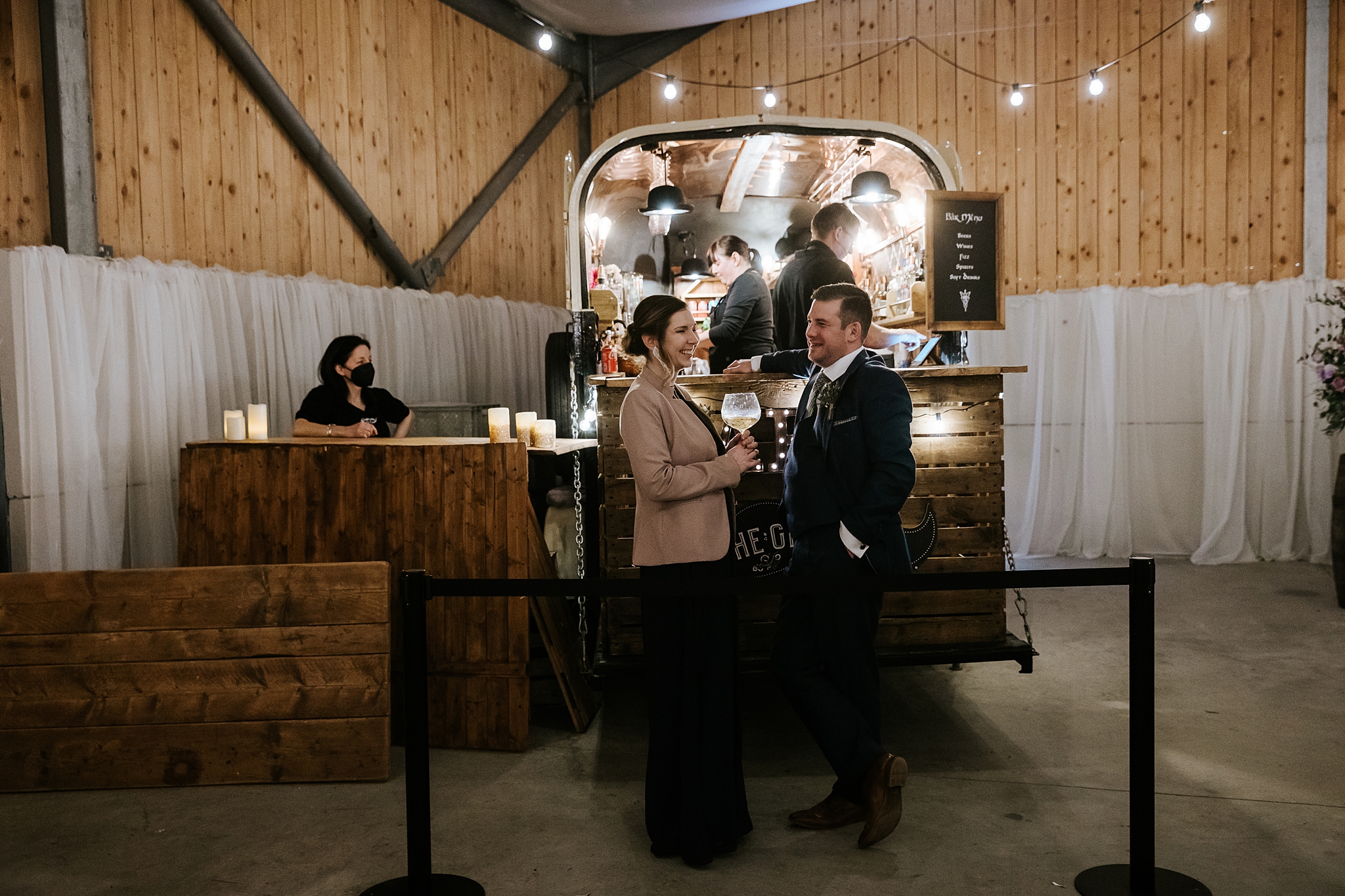 guests enjoying a drink at the Gin Thing bar at a barn celtic folklore theme wedding at Carrick Castle Estate in Scotland