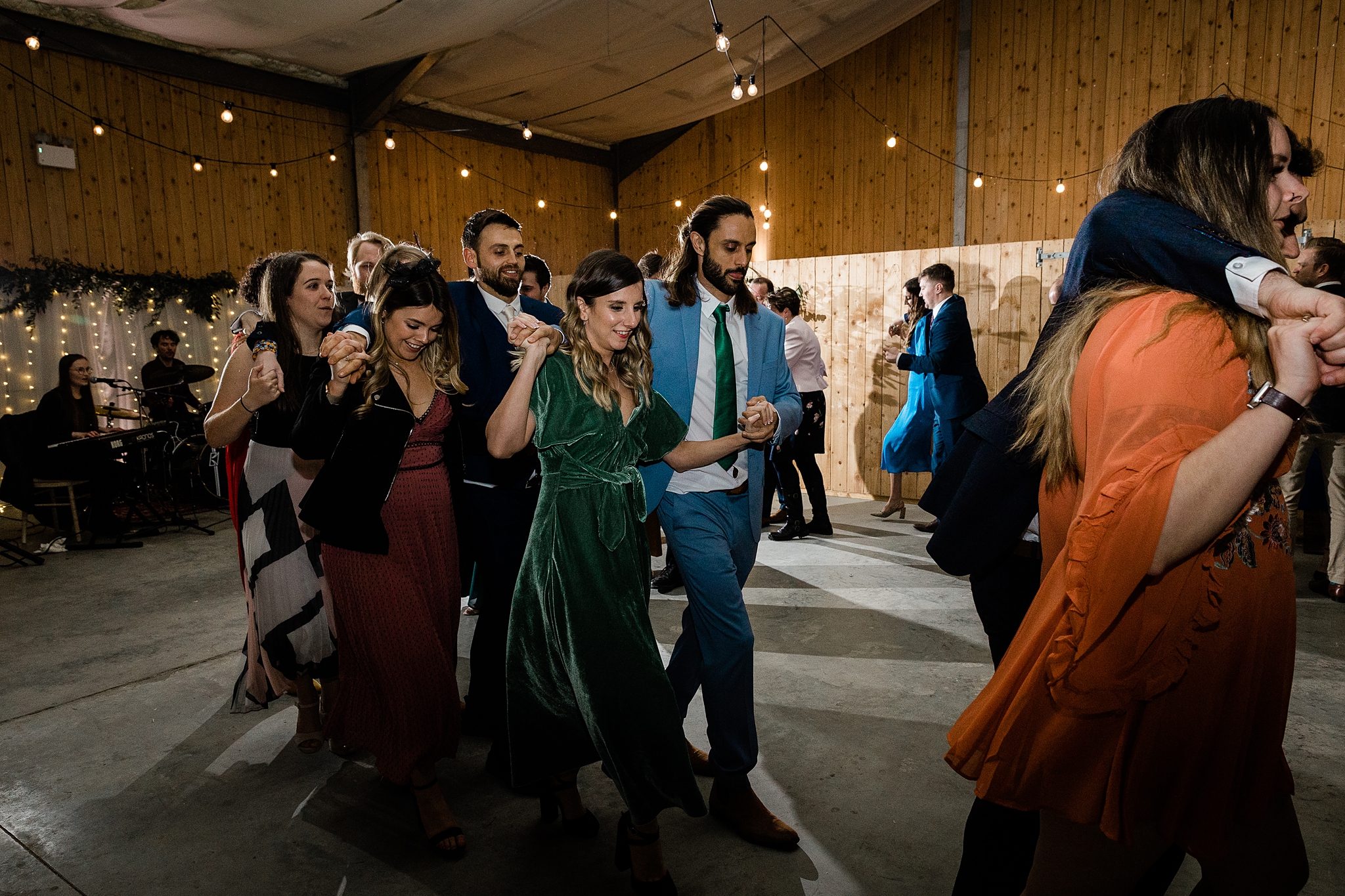 wedding guests ceilidh dancing at a barn wedding at Carrick Castle Estate in Scotland