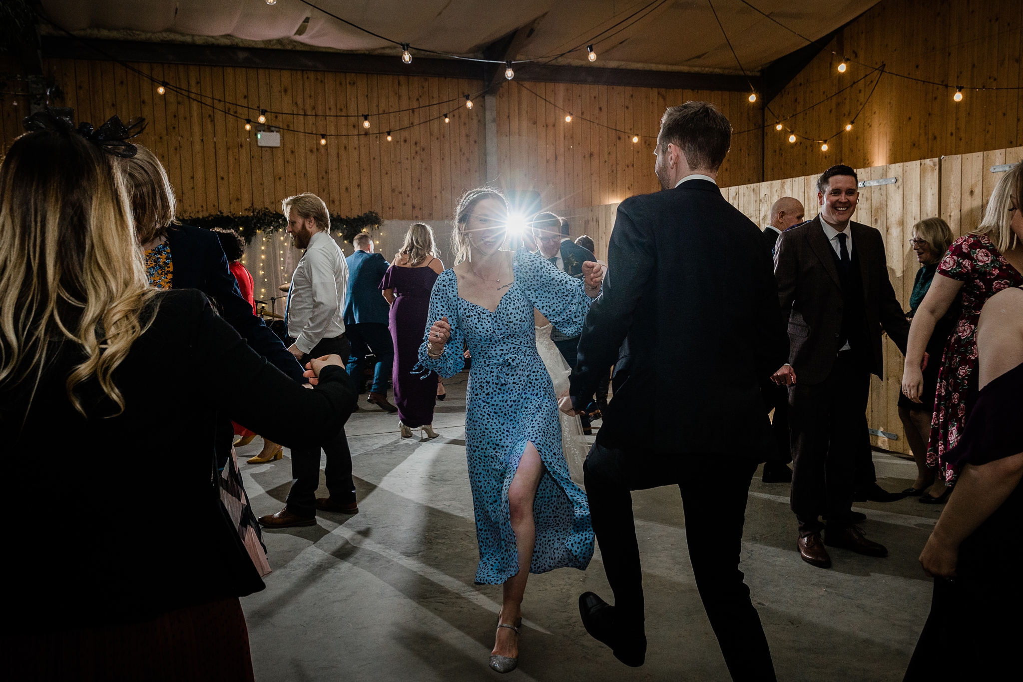 wedding guests ceilidh dancing at a barn wedding at Carrick Castle Estate in Scotland
