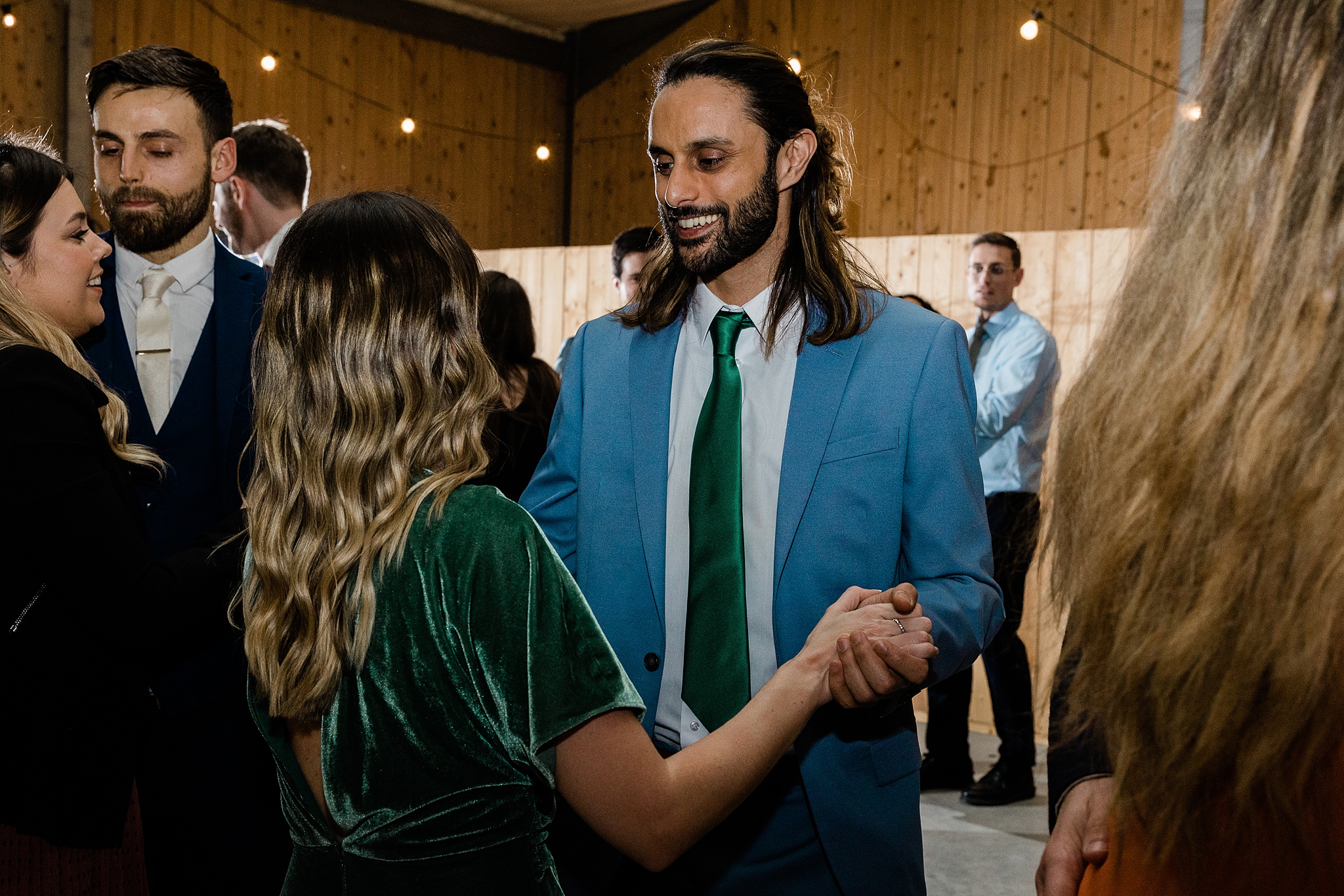 wedding guests ceilidh dancing at a barn wedding at Carrick Castle Estate in Scotland