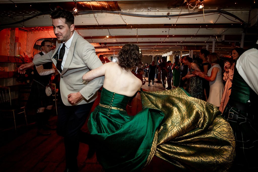 bride dancing in a green wedding dress at a ceilidh