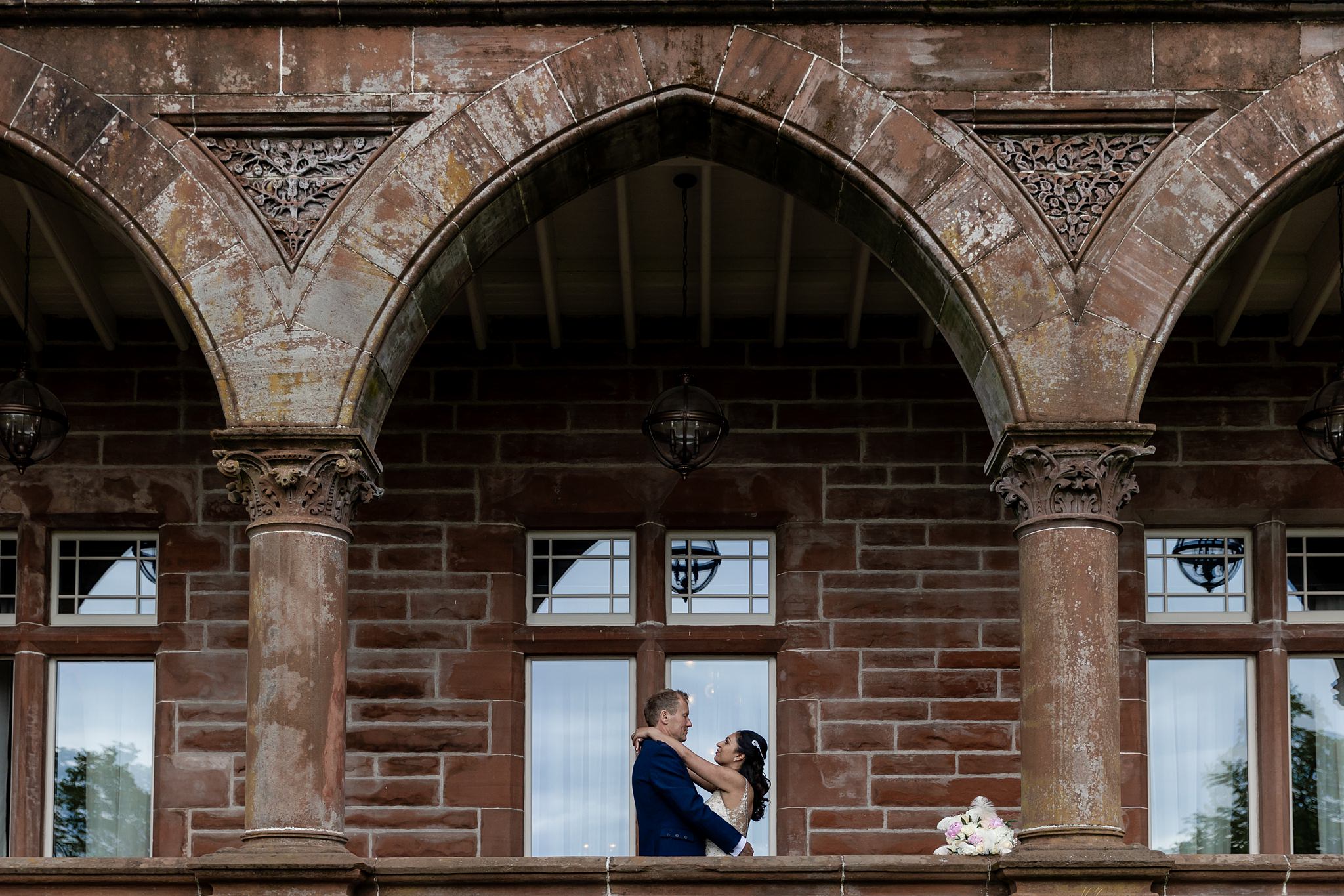 bride and groom embracing on terrace at Boclair House