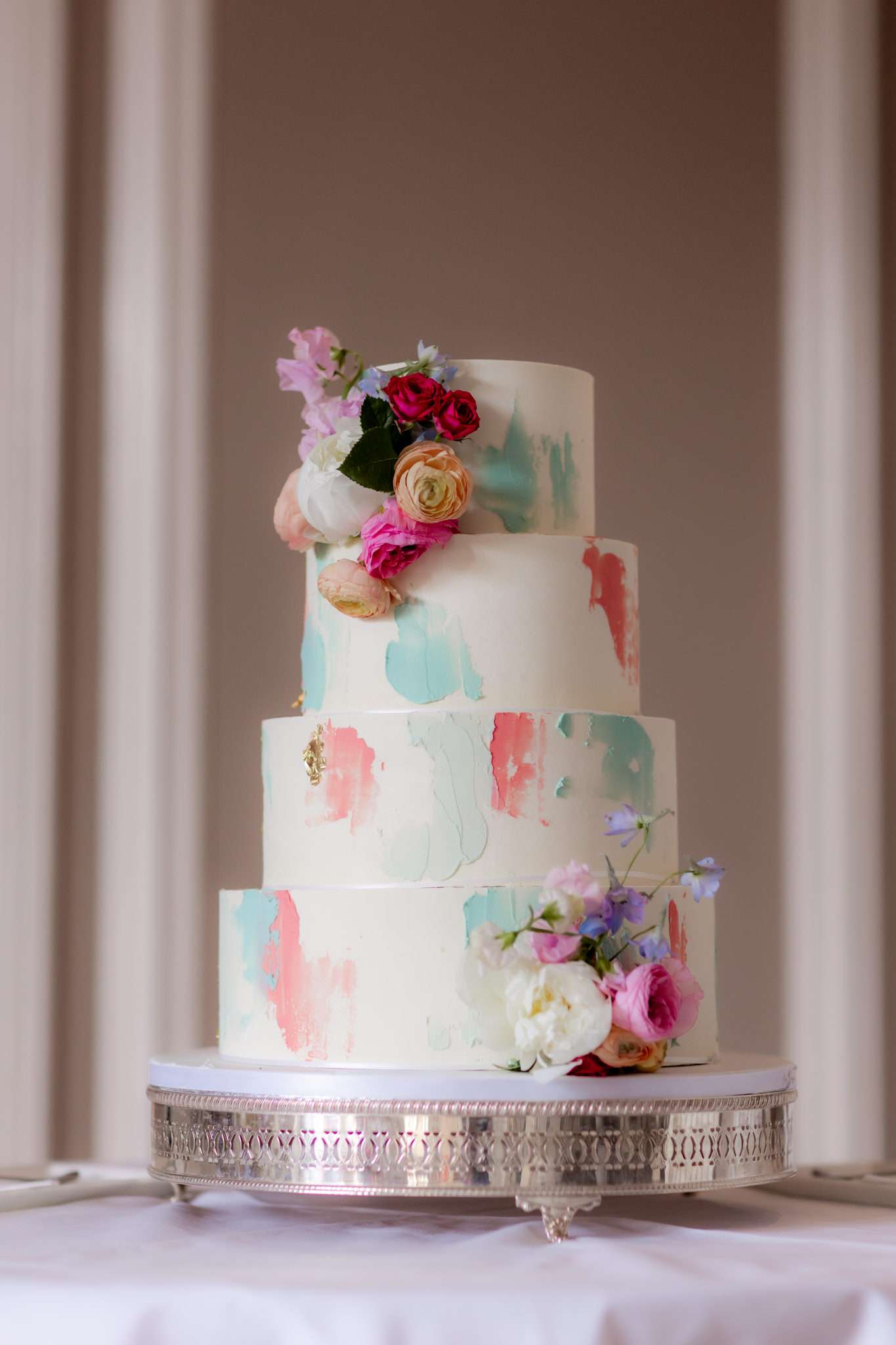 pink and mint and white four tier wedding cake with flowers