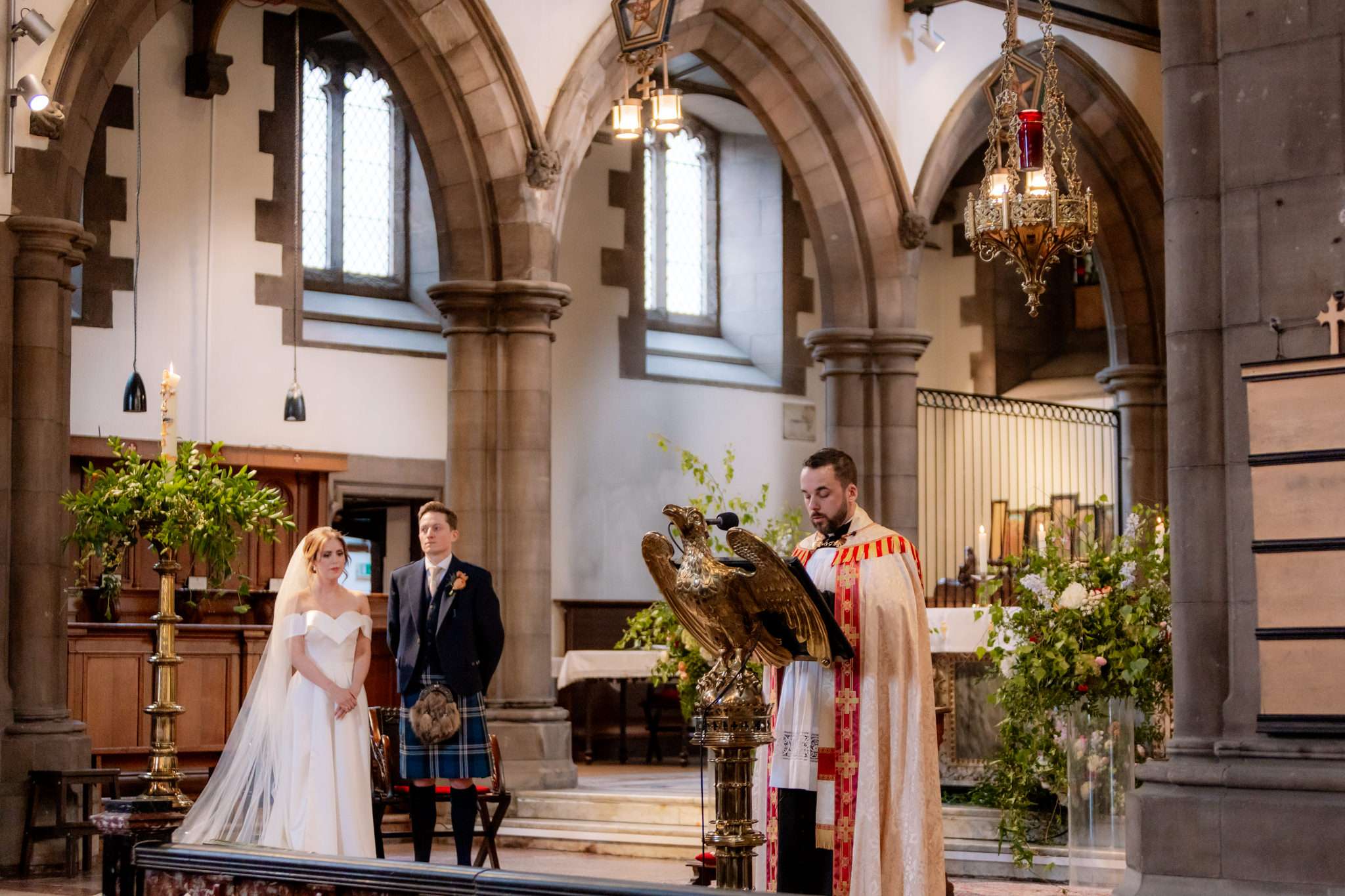 Priest, bride and groom during a wedding ceremony at  St Mary's Cathedral Edinburgh 
