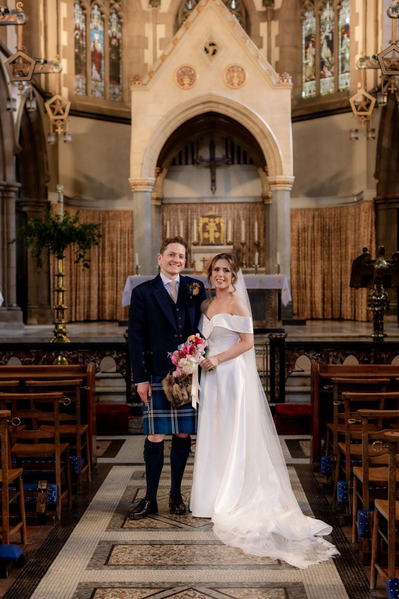 bride and groom standing in the aisle during a wedding ceremony at  St Mary's Cathedral Edinburgh 