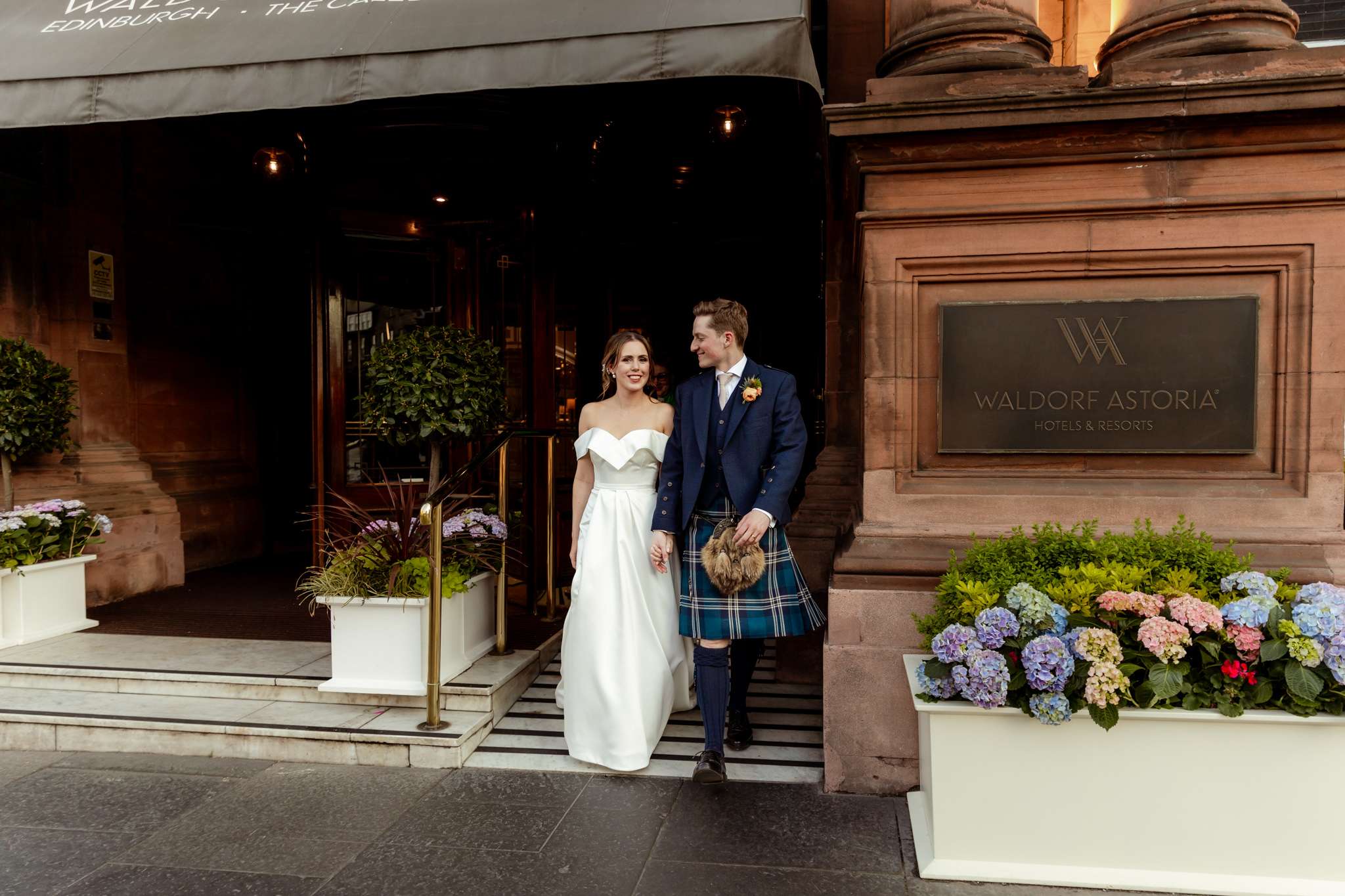 bride and groom outside front door at Caledonian Waldorf Hotel in Edinburgh 