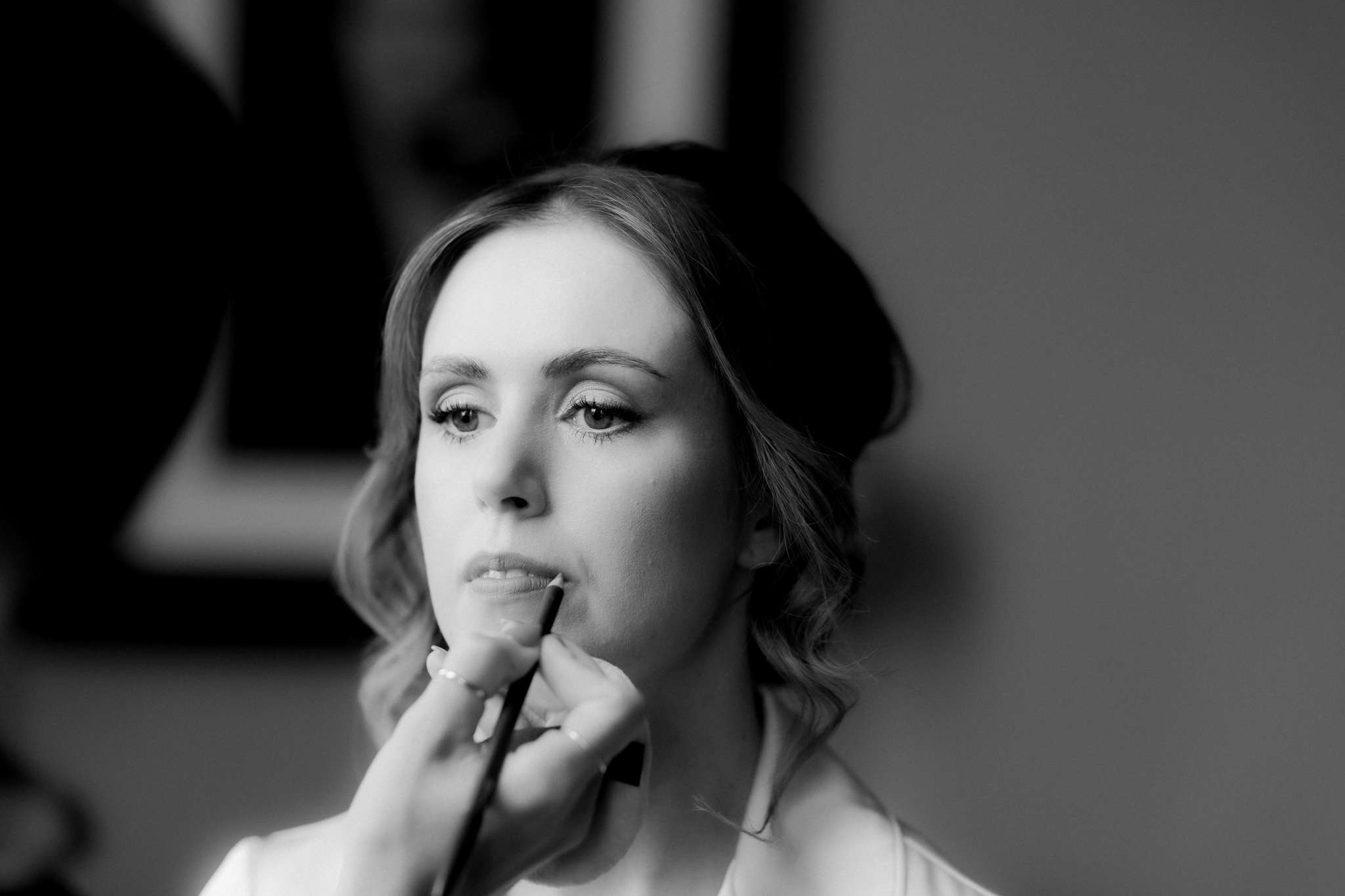 bride having lip liner applied 