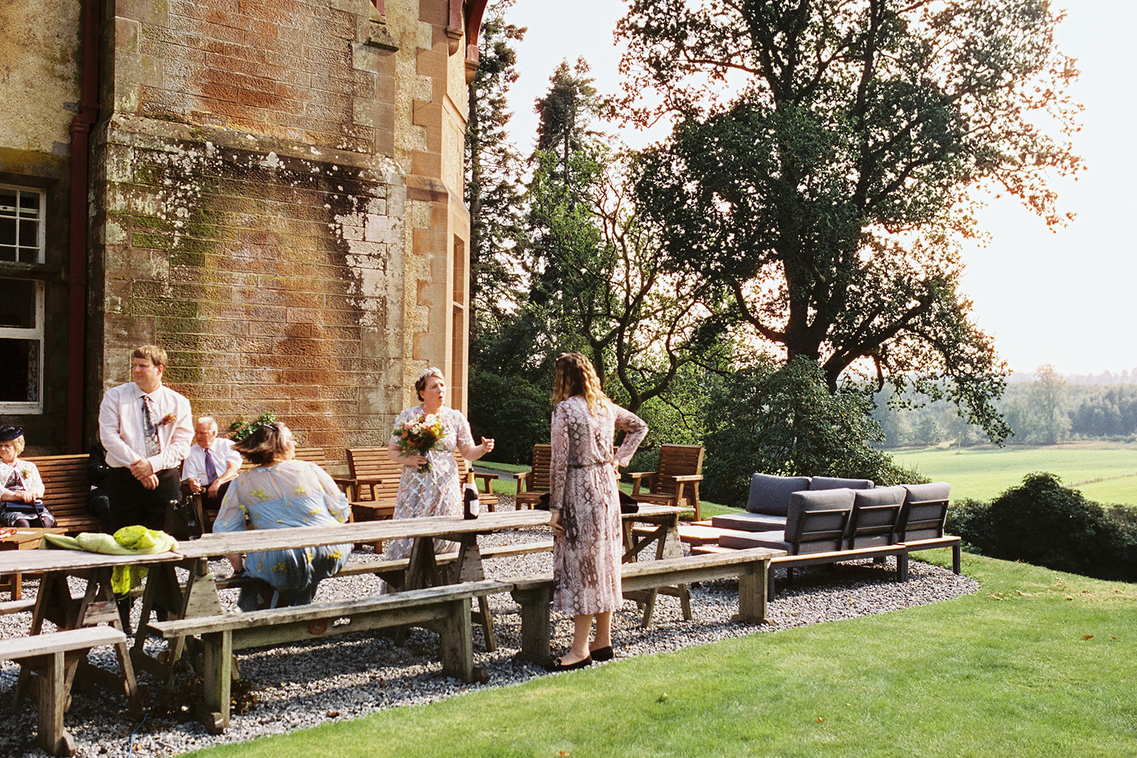 wedding guests chatting outside  Dungarthill House in Dunkeld