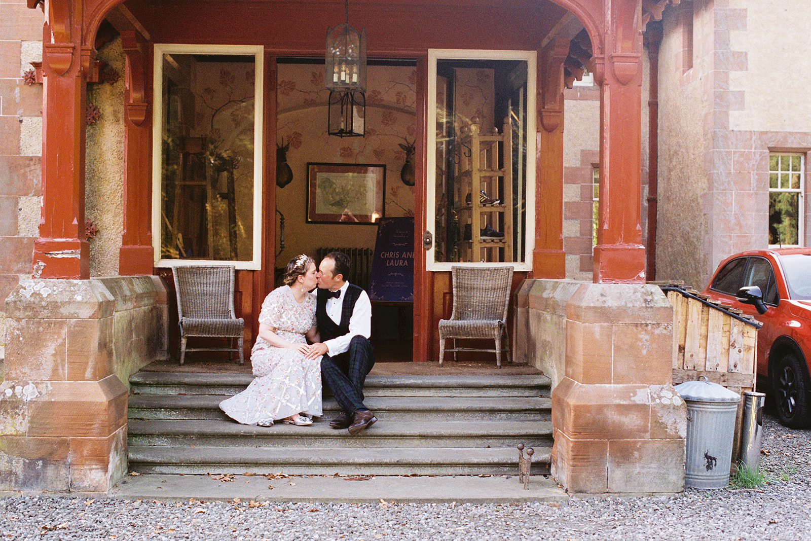 film photography image of a bride and groom sitting on steps at Dungarthill House, Dunkeld