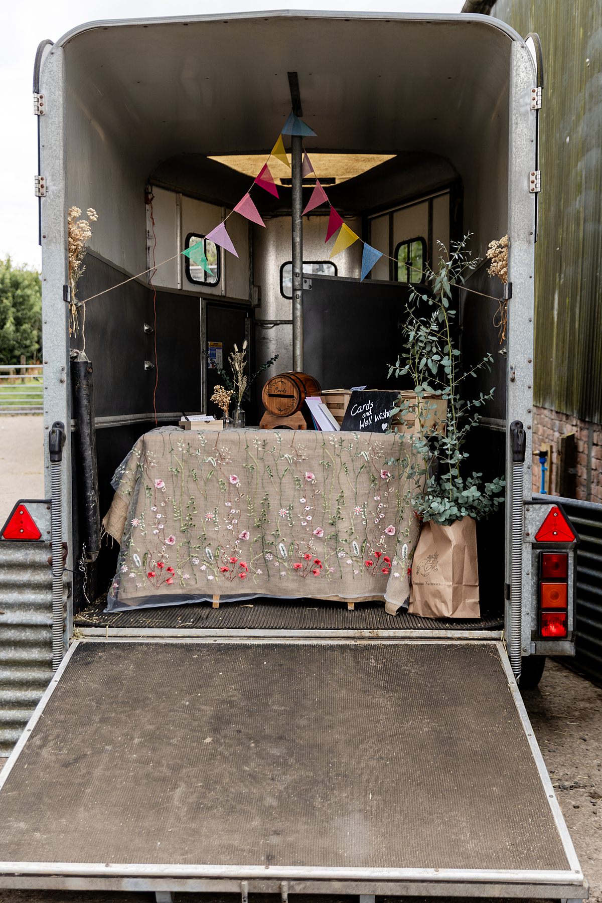 horse box converted into gift table at a farm wedding in scotland
