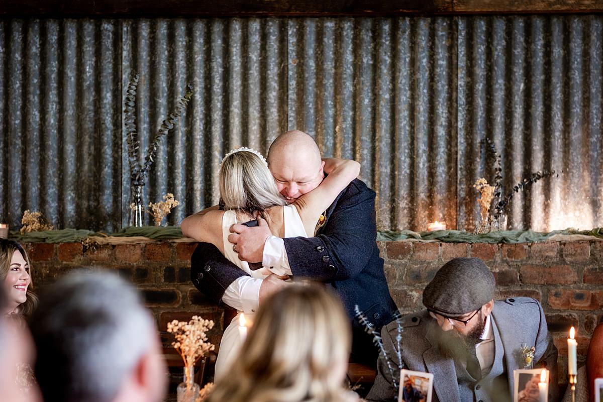 best man hugging a bride