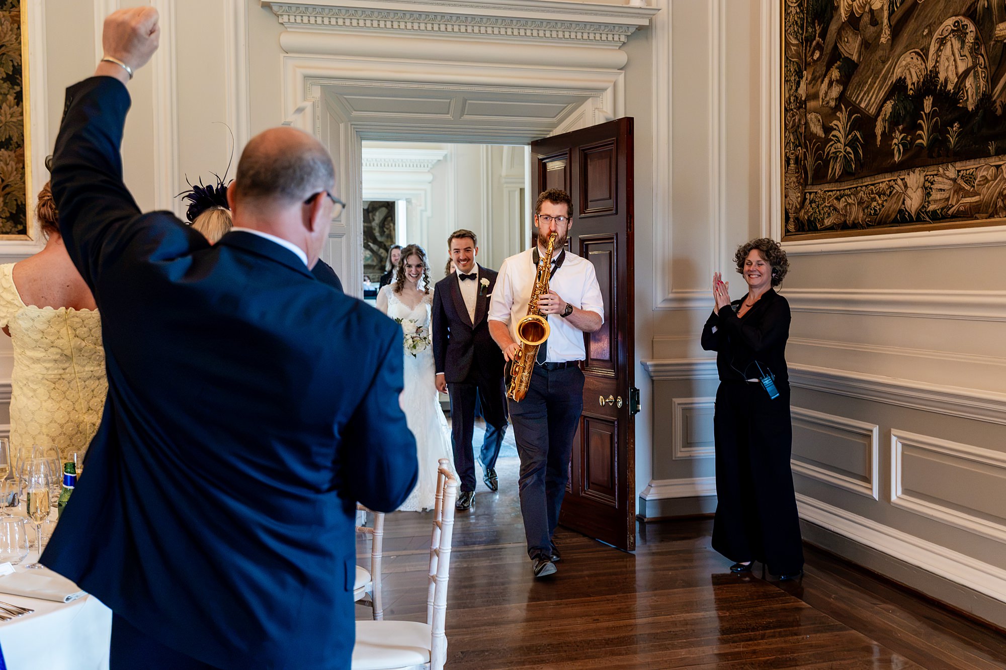 saxaphonist leading bride and groom in to a wedding breakfast at a Hopetoun House wedding
