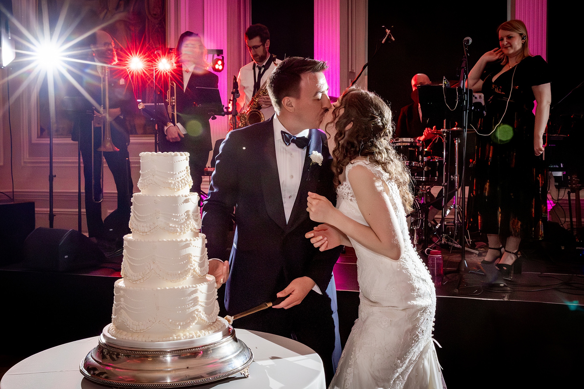 bride and groom kissing while cutting the cake at Hopetoun House wedding