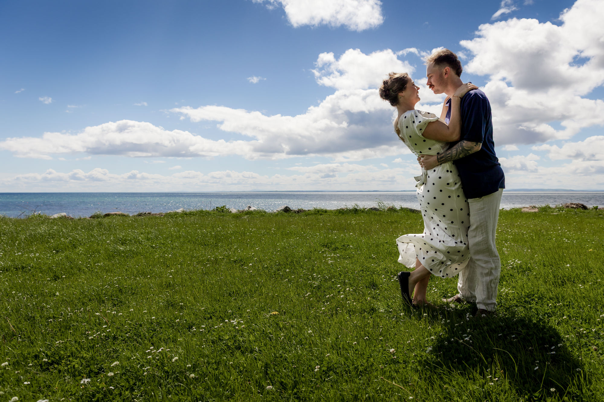 couple dancing in the breeze on the shore of the Moray firth. 